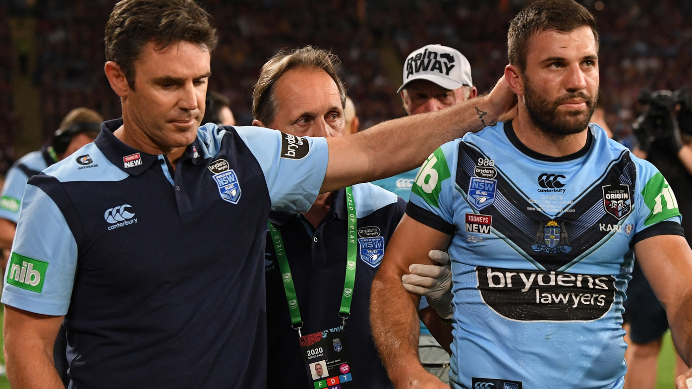 Blues coach Brad Fittler checks on James Tedesco after the game