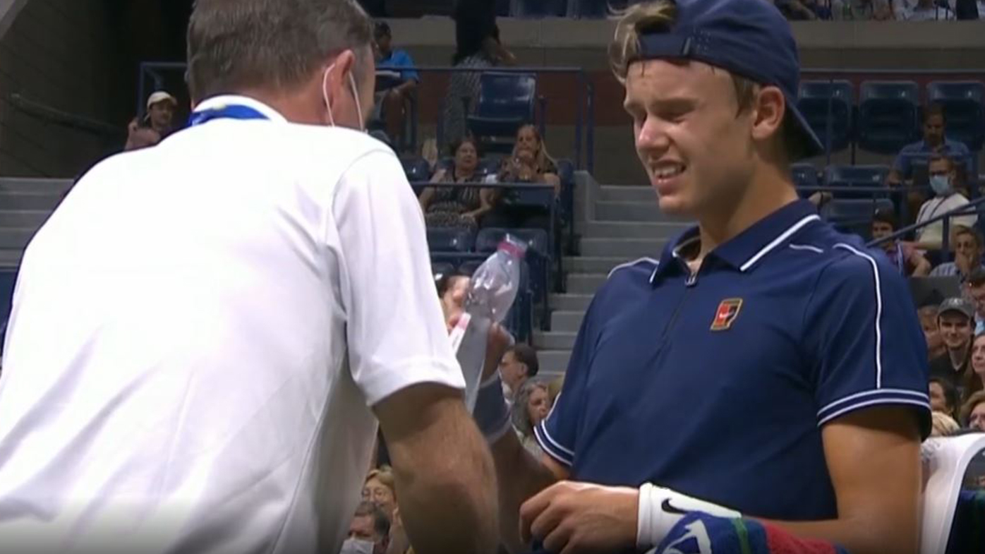 Holger Rune gets treatment on his leg during his match against Novak Djokovic.