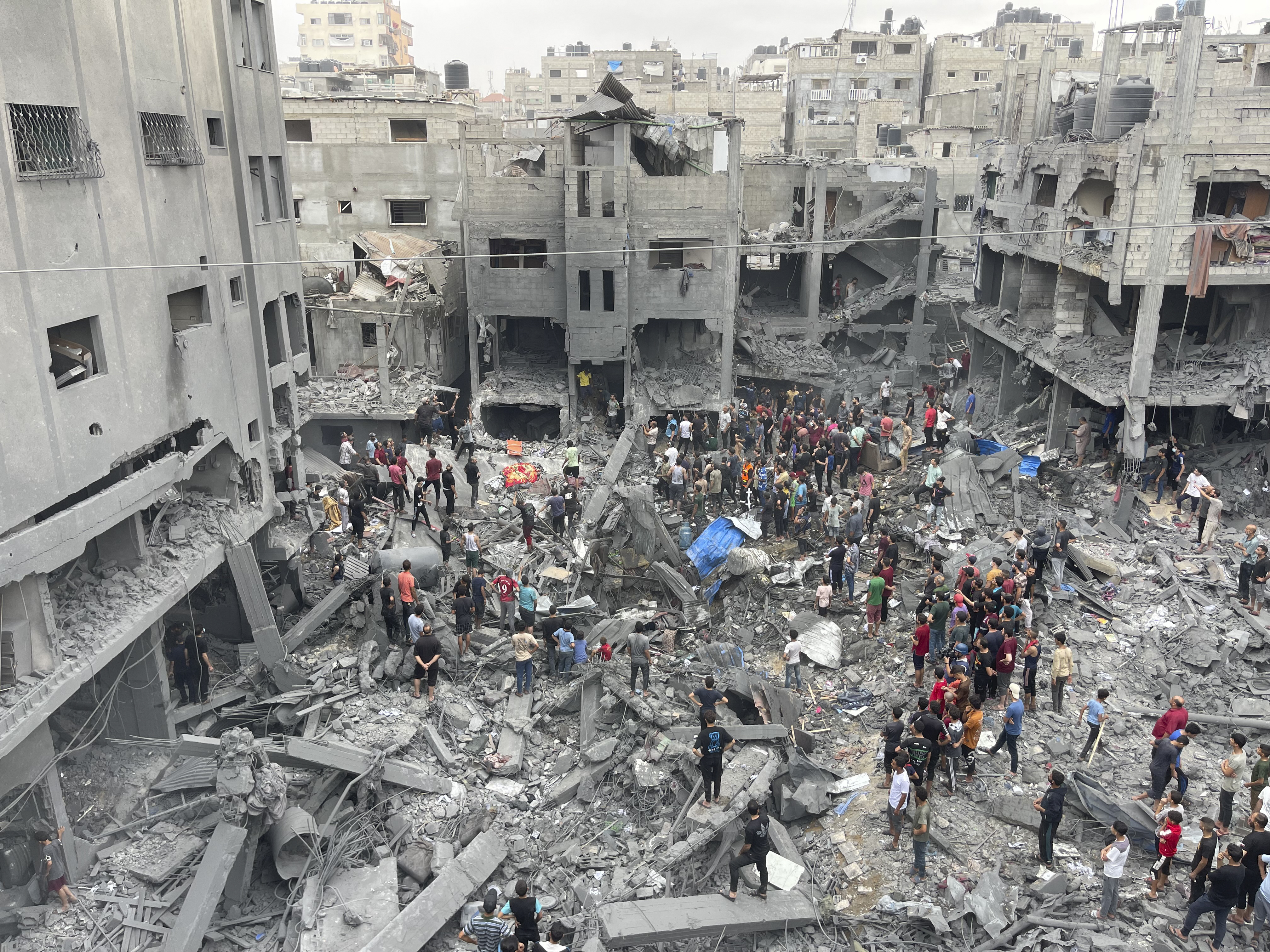 Palestinians look for survivors after an Israeli airstrike on buildings at Shati refugee camp, Gaza Strip, Friday, Oct. 27, 2023. 