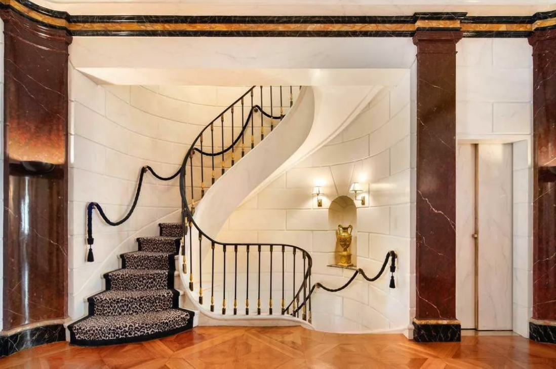 The grand reception level with its marble pillars and stately stairs.