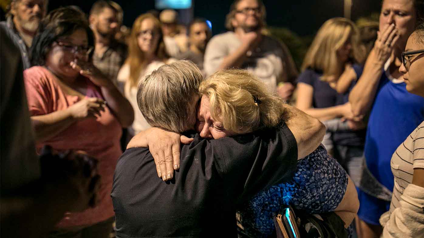 Texas Governor Greg Abbott embraces Ann Montgomery, a Sunday School teacher at the Sutherland Springs First Baptist Church.