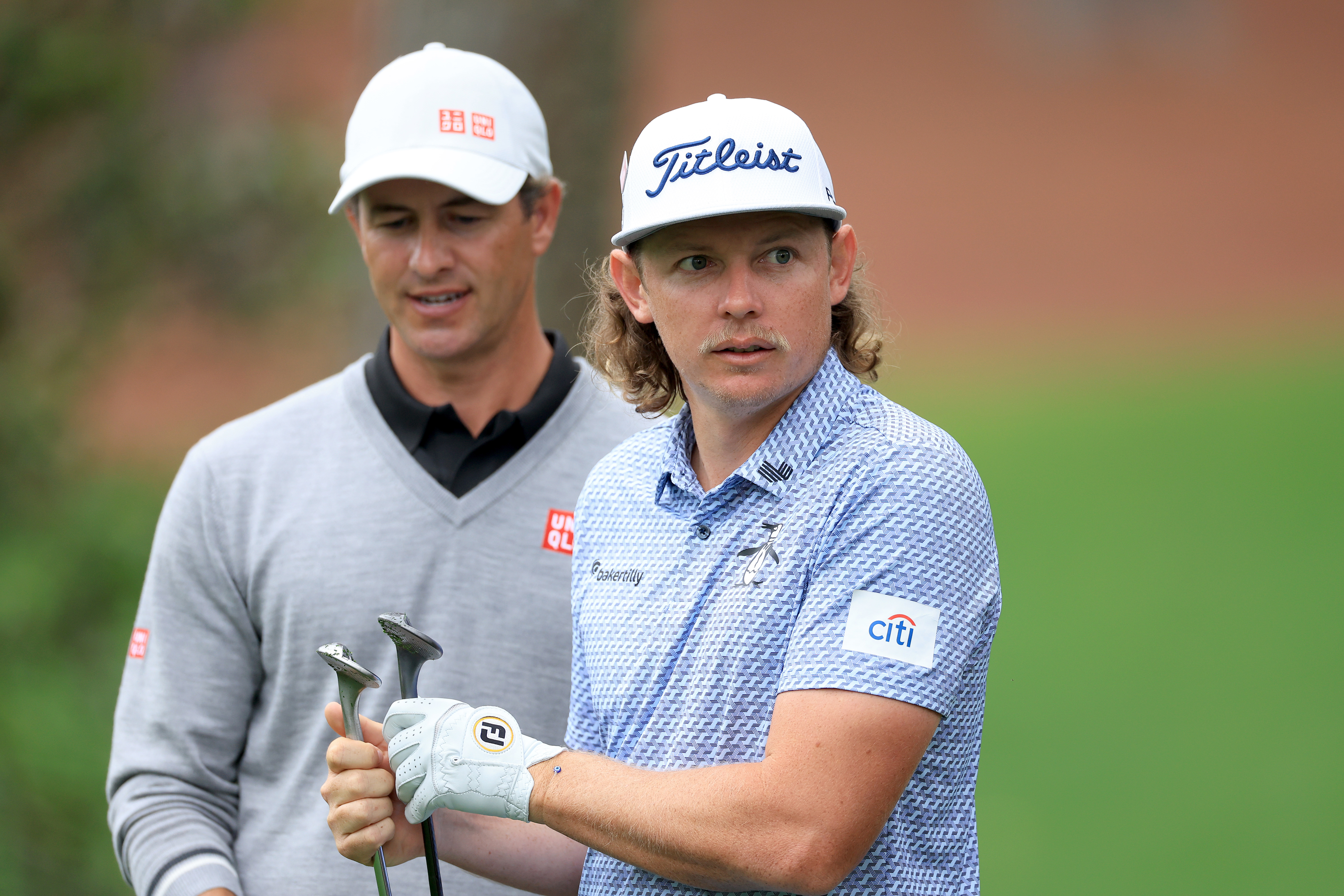 Adam Scott of Australia talks to Cameron Smith during a practice round ahead of the 2023 Masters Tournament at Augusta National.