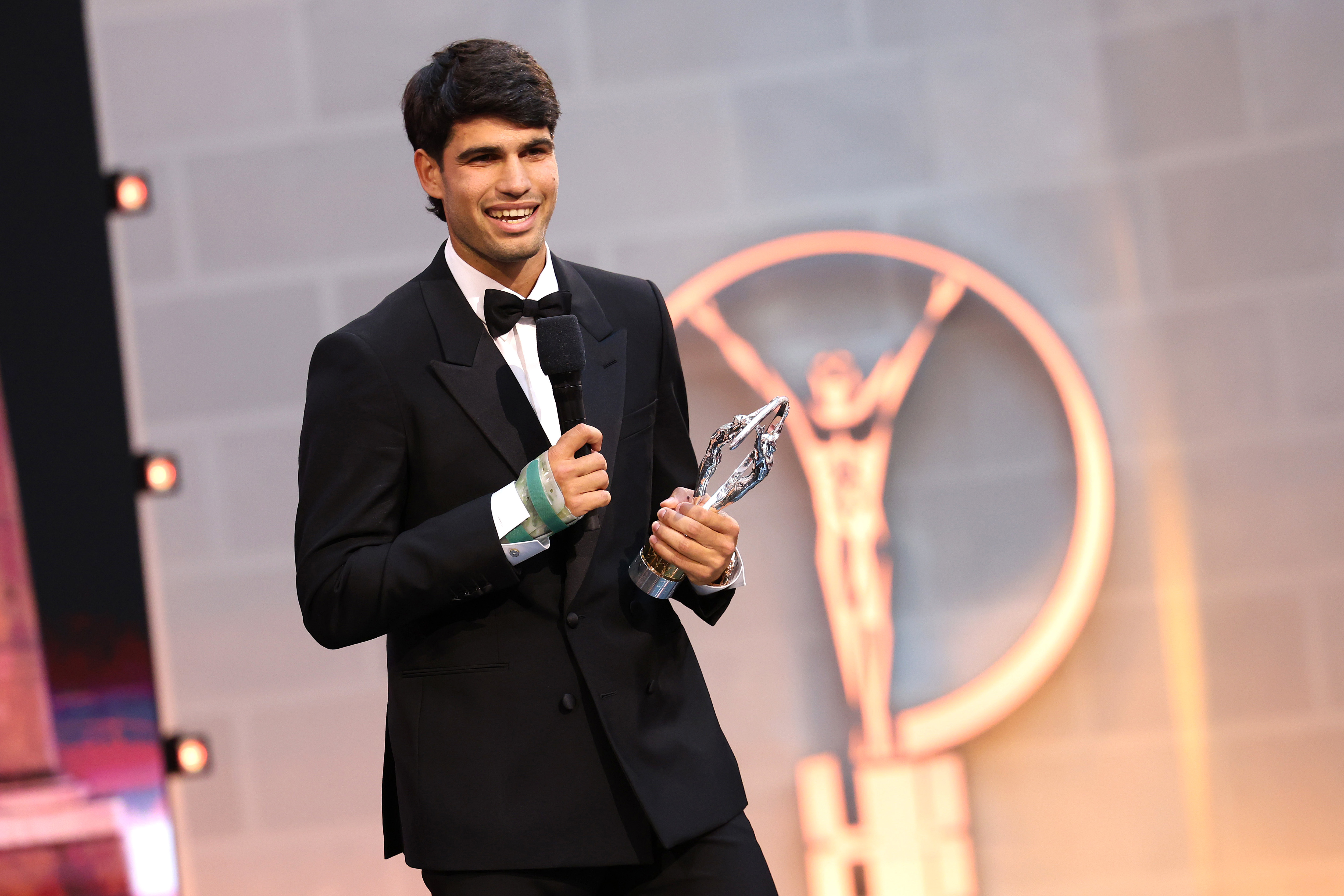 Carlos Alcaraz accepts the Laureus World Sportsman of the Year award, with a cast on his wrist.