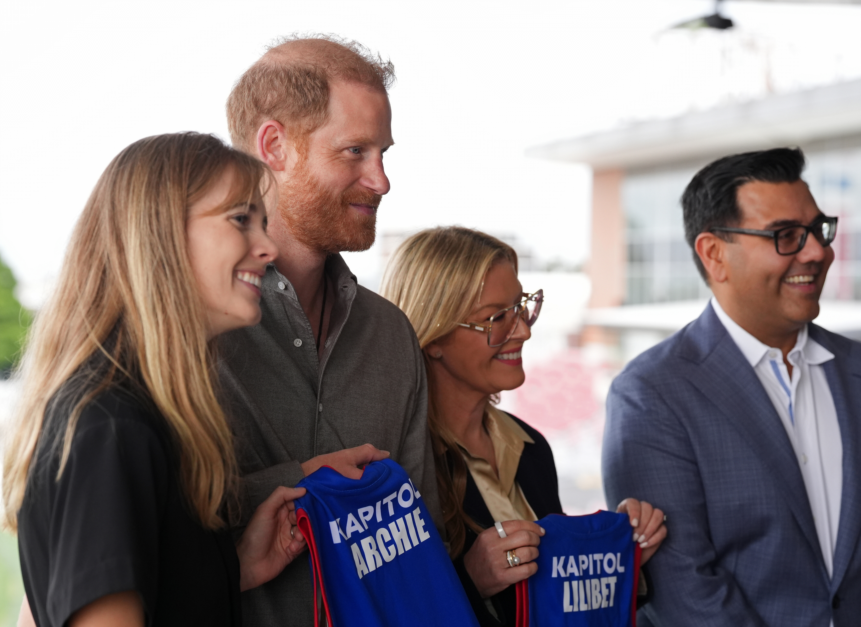 Britain's Prince Harry, the Duke of Sussex, is presented with Western Bulldogs Archie and Lilibet jerseys during a visit to Movember at the Western Bulldogs Headquarters at Mission Whitten Oval, in Footscray, Melbourne, Australia, Wednesday, April 15, 2026. (Jonathan Brady/Pool Photo via AP)