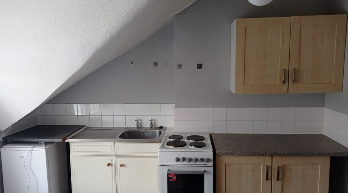 This tiny one-bedroom flat in South London with the bed next to the oven has gone on the market and is asking just under $2k in monthly rent