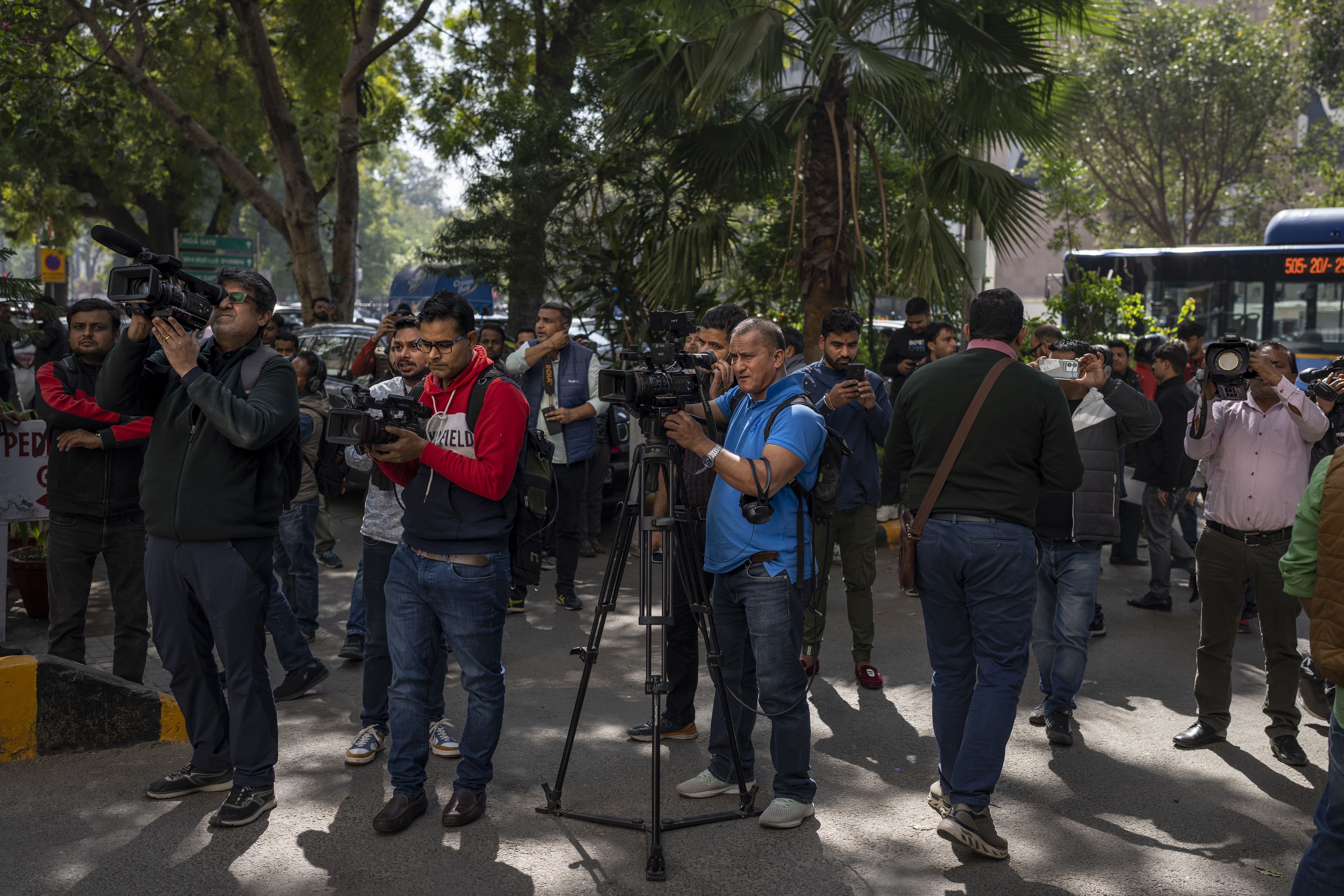 Media personnel report standing outside a building housing BBC office in New Delhi, India, Tuesday, Feb. 14, 2023. 