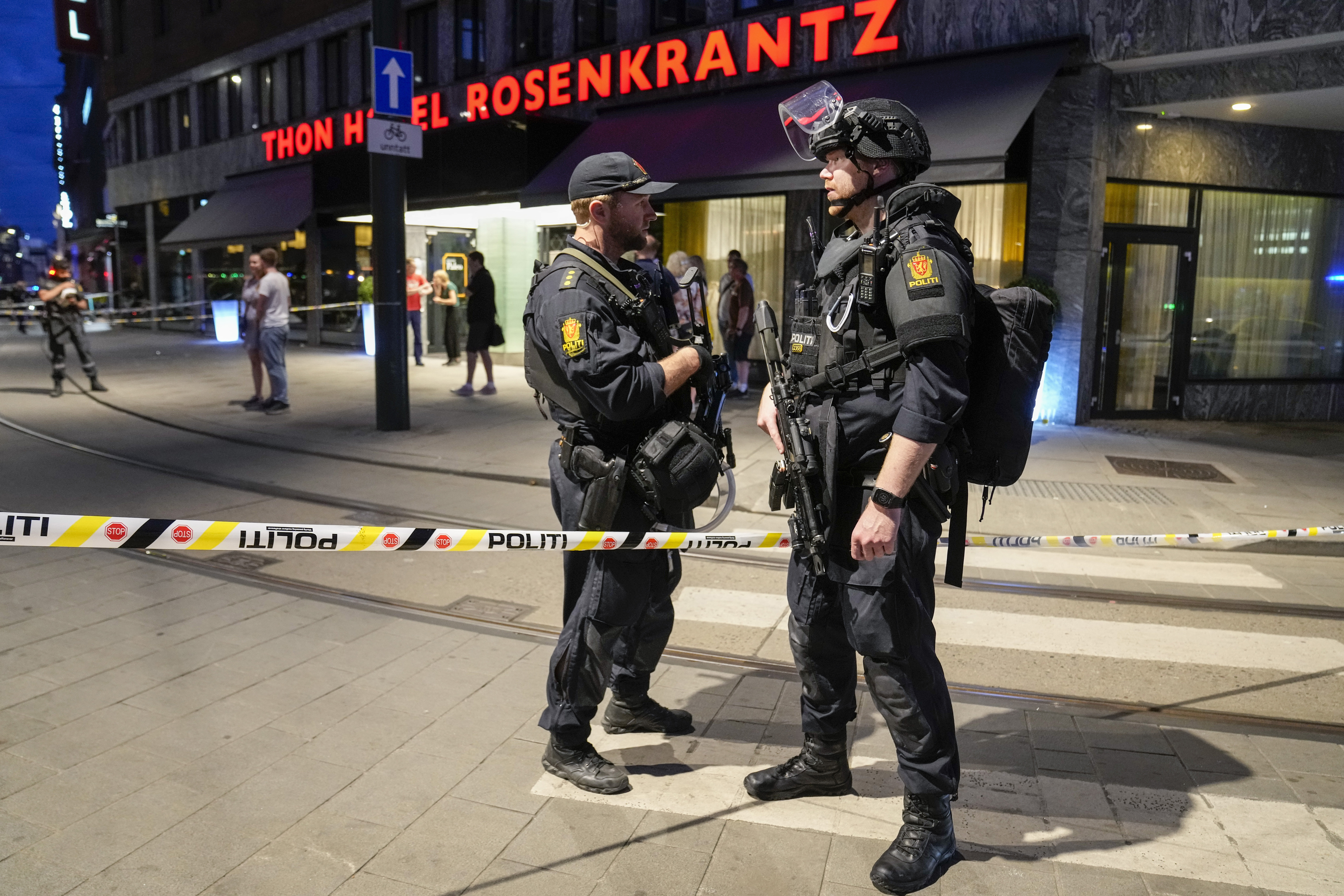 Police stand guard outside a bar in central Oslo, early Saturday, June 25, 2022. Norwegian police say a few people have been killed and more than a dozen injured in a mass shooting. (Javad Parsa/NTB via AP)