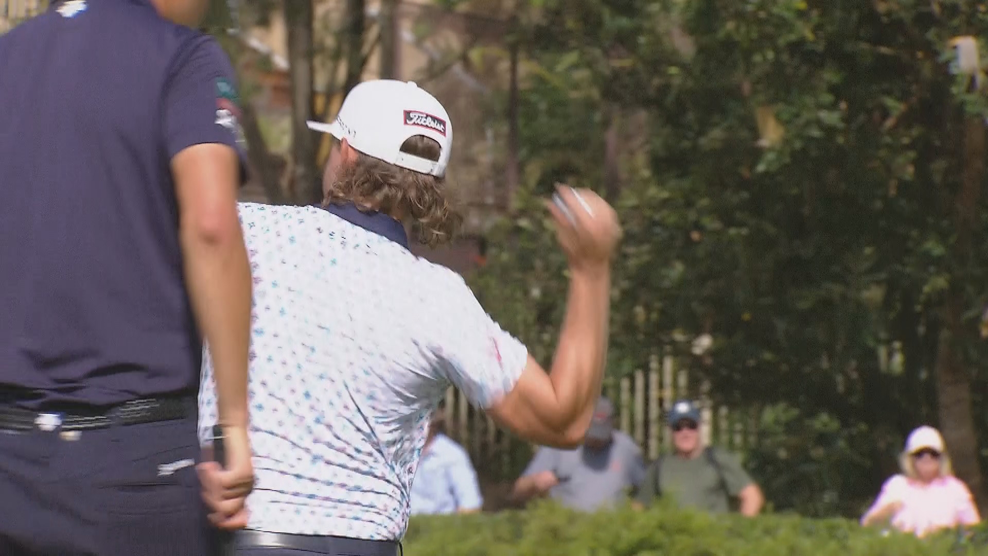Cameron Smith throws his ball into the pond after making bogey at the 17th.