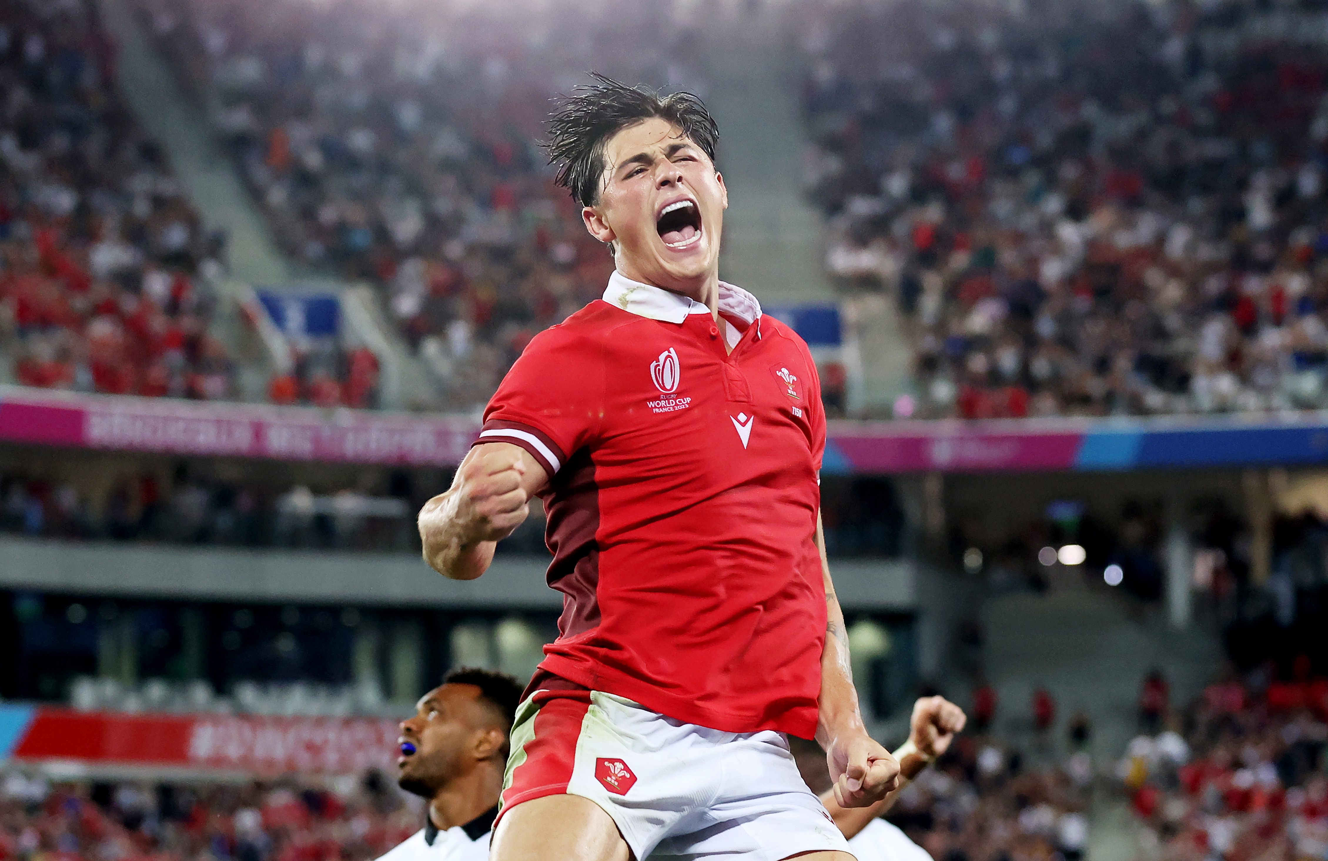 Louis Rees-Zammit of Wales celebrates victory at the final whistle.