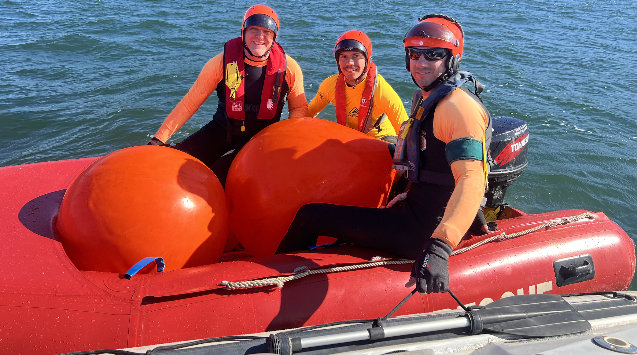 From left to right: Peter Bergman, Gamay ranger David Johnson and Chris Burrow-Jones beam at the camera after Johnson aced his training.