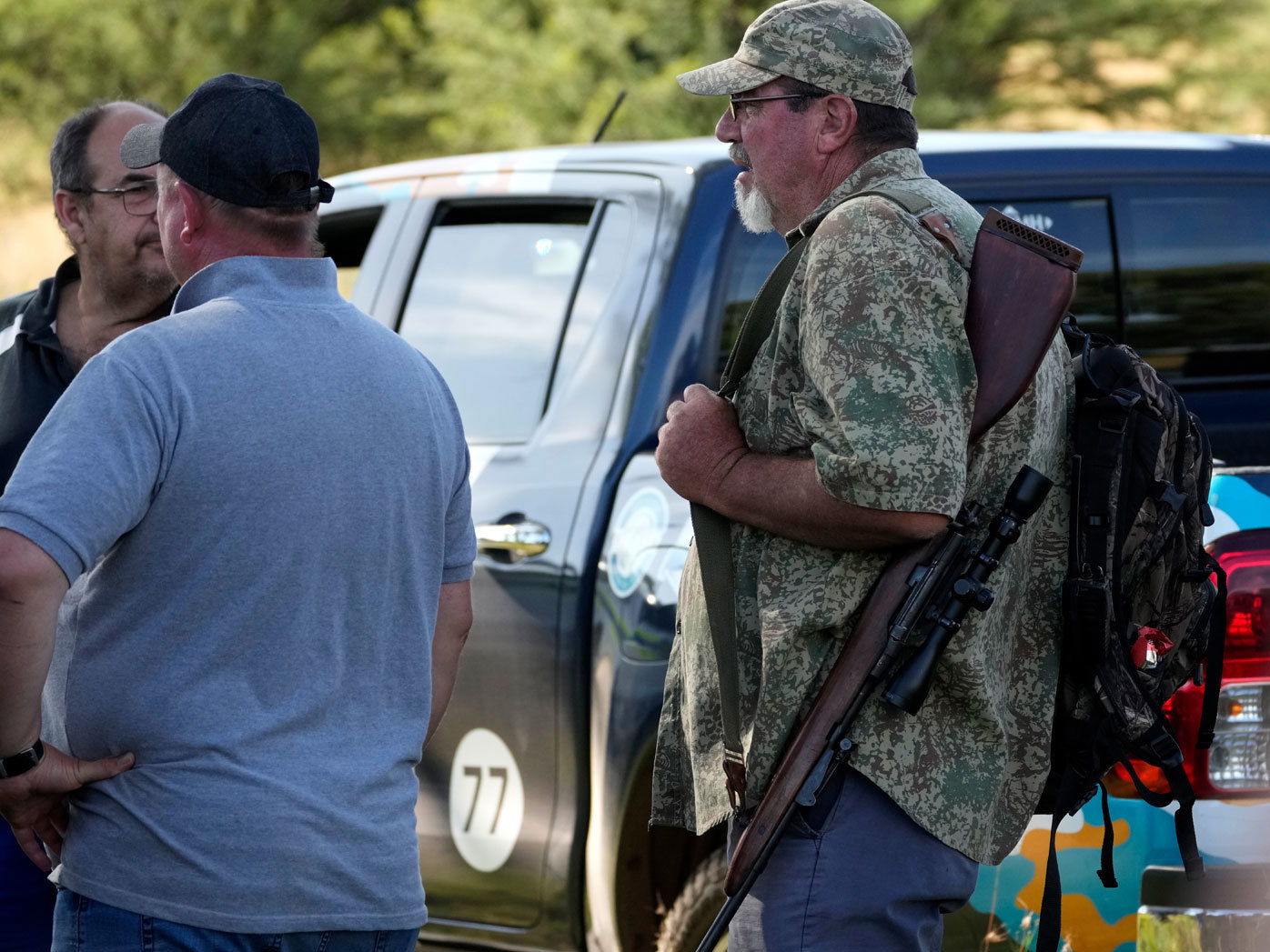 Local community police gather to plan a search for a tiger that escaped from its enclosure, in Walkerville, south of Johannesburg