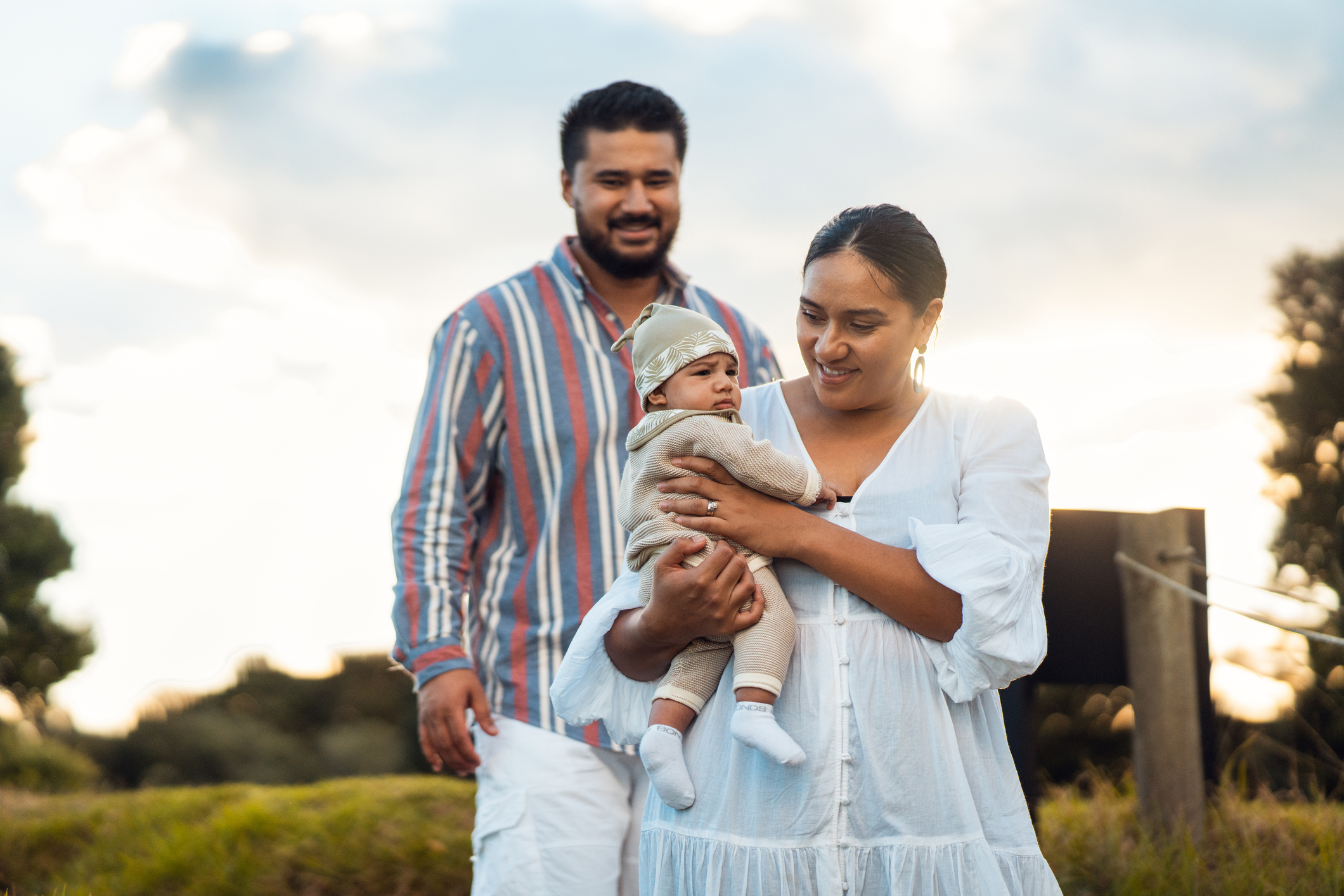 Happy couple enjoying outdoor with their small child.