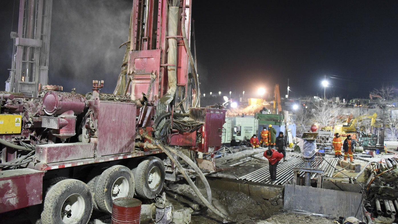 Chinese state media say 12 out of 22 workers trapped for a week by an explosion in the gold mine are alive, as hundreds of rescuers seek to bring them to safety.