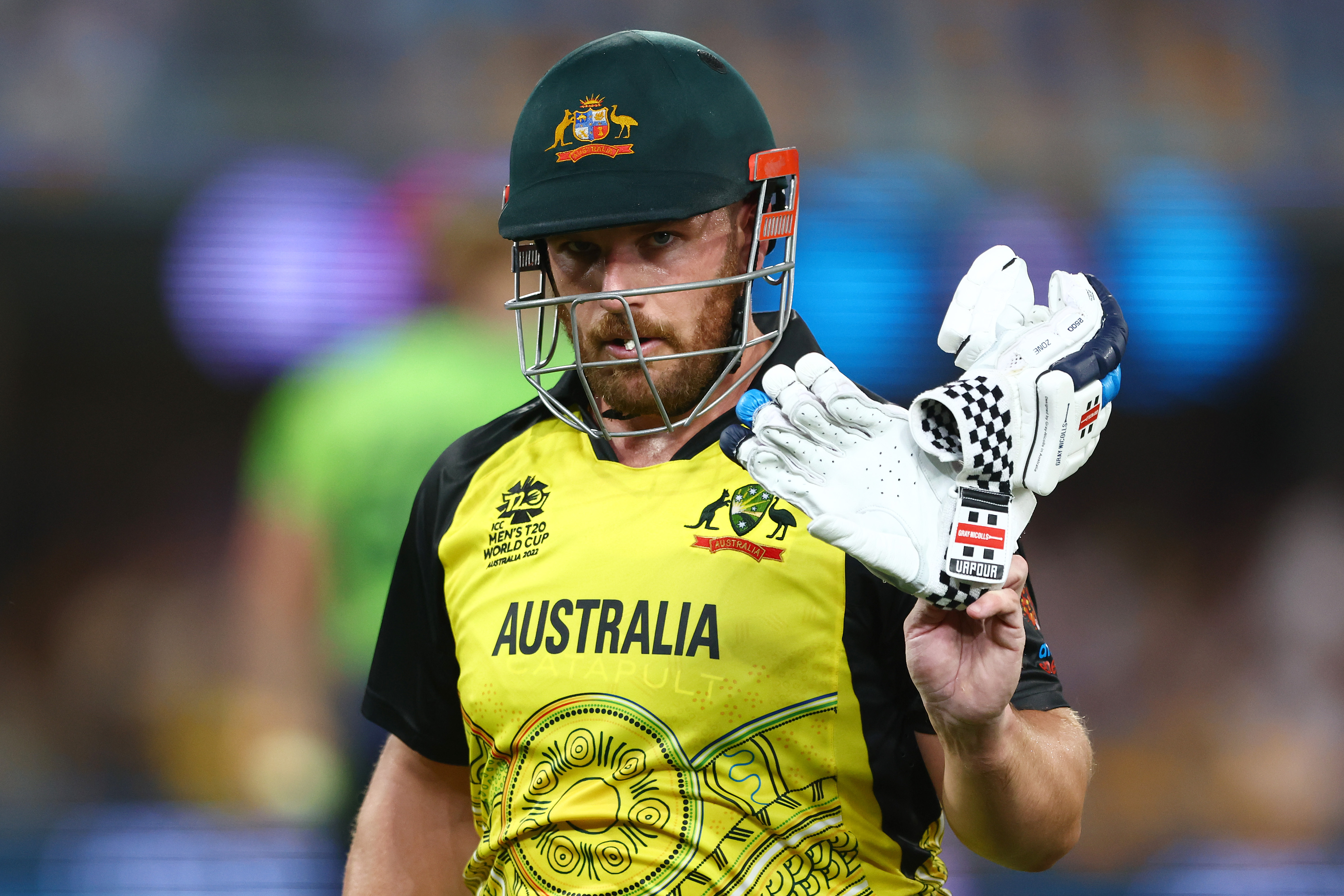 BRISBANE, AUSTRALIA - OCTOBER 31: Aaron Finch of Australia walks off the field after being dismissed by Barry McCarthy of Ireland for 63 runs during the ICC Men's T20 World Cup match between Australia and Ireland at The Gabba on October 31, 2022 in Brisbane, Australia. (Photo by Chris Hyde-ICC/ICC via Getty Images)