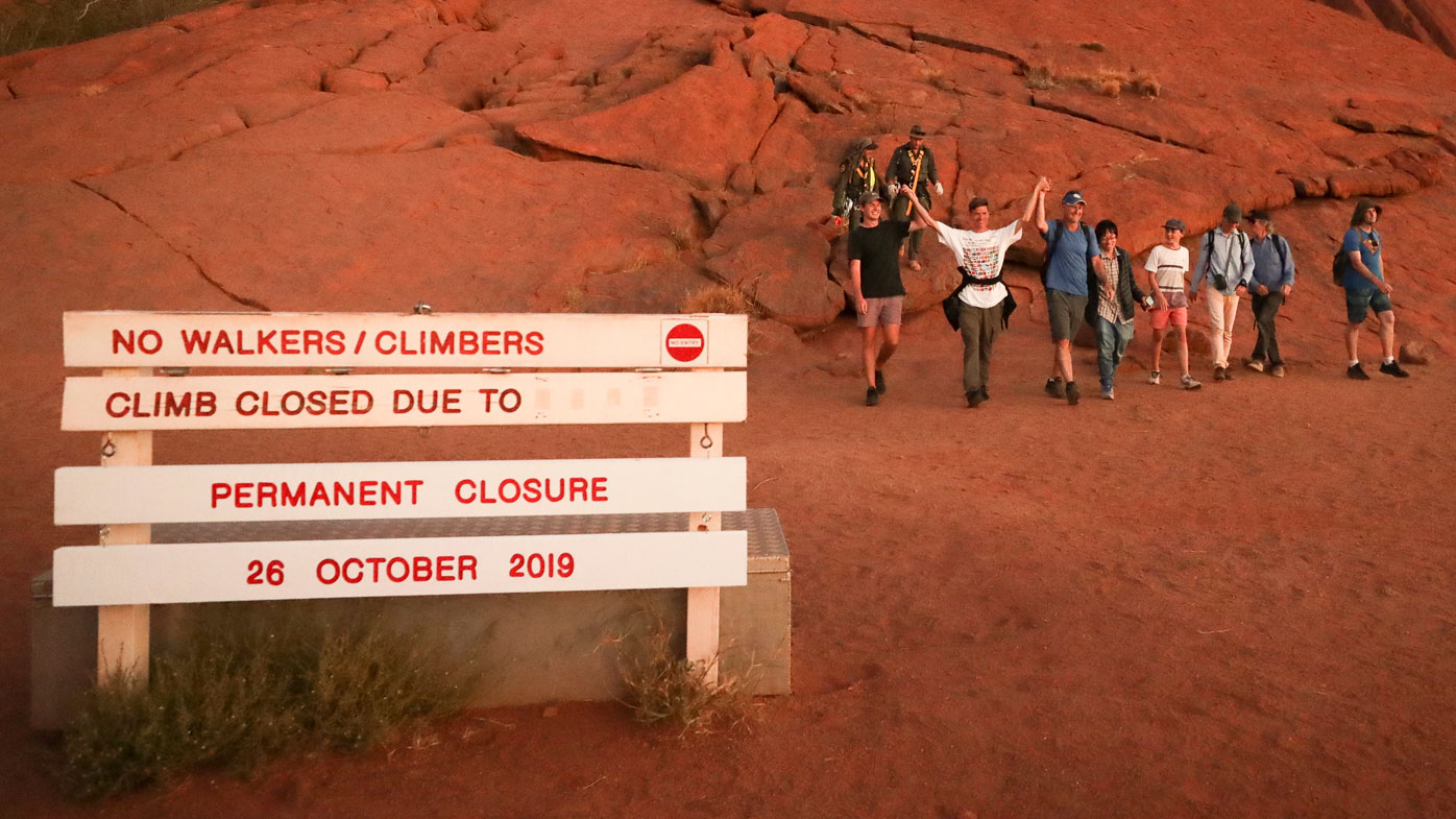 Uluru climbing ban Uluru wakes to a new dawn as climbing finishes