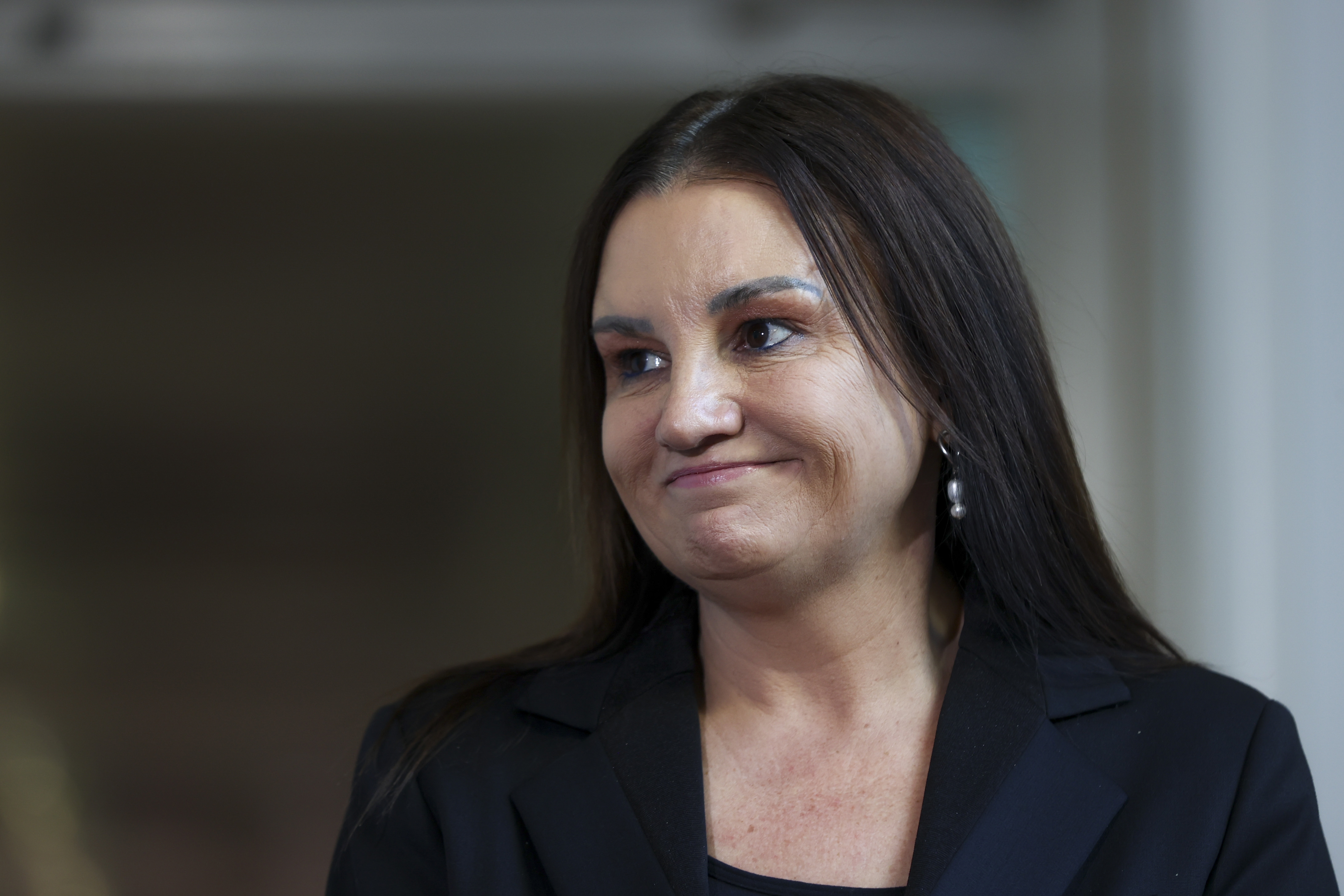 Senator Jacqui Lambie speaks to the media at Parliament House in Canberra on May 13, 2024.