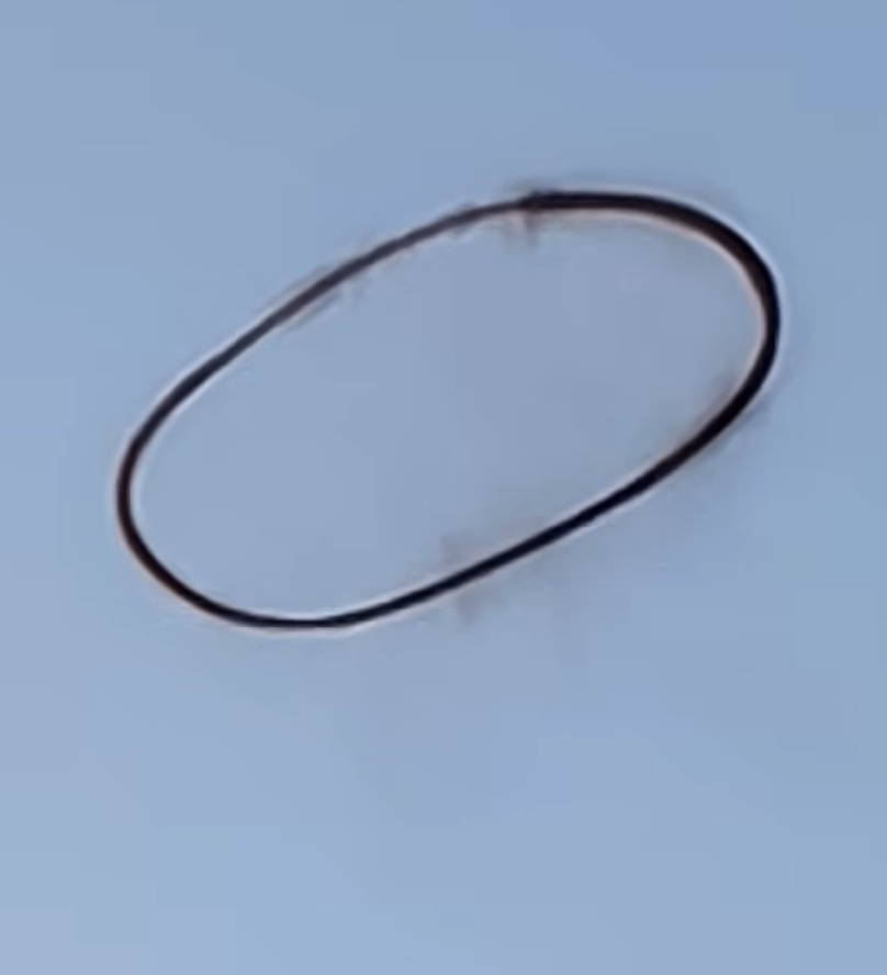 A black ring in the sky has slowly disappeared before shocked witnesses, raising questions about its origin. 