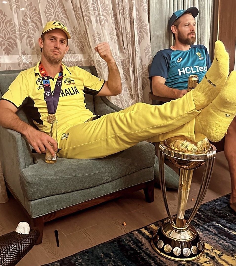 Mitchell Marsh with his feet resting on the World Cup trophy after Australia's victory over India.