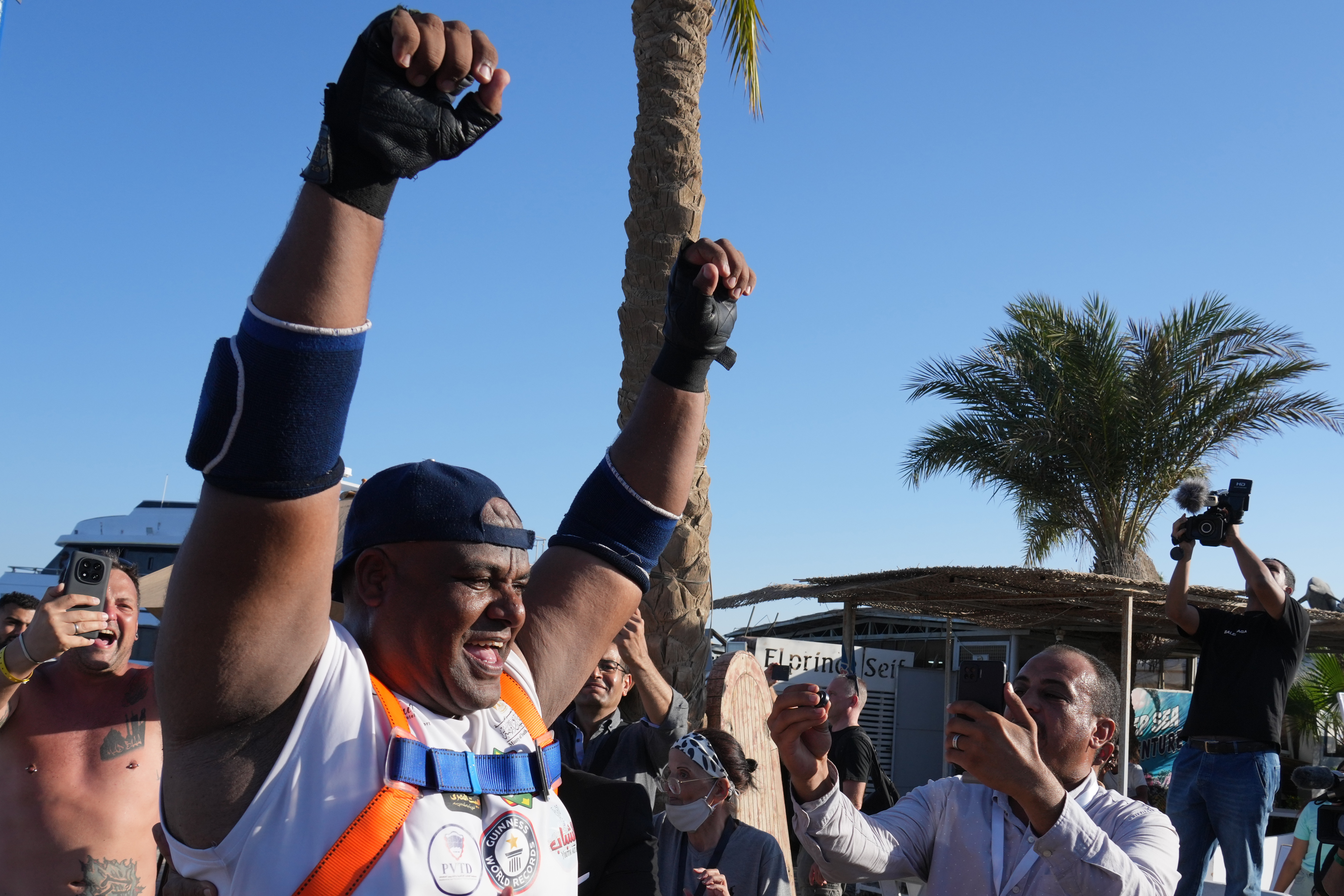 Egyptian wrestler Ashraf Mahrous, better known as Kabonga, celebrates after he manages to pull a 700-ton ship across the water with a rope held only by his teeth at the marina of the Red Sea resort of Hurghada, Egypt, Saturday, Sept. 27, 2025. (AP Photo/Amr Nabil)