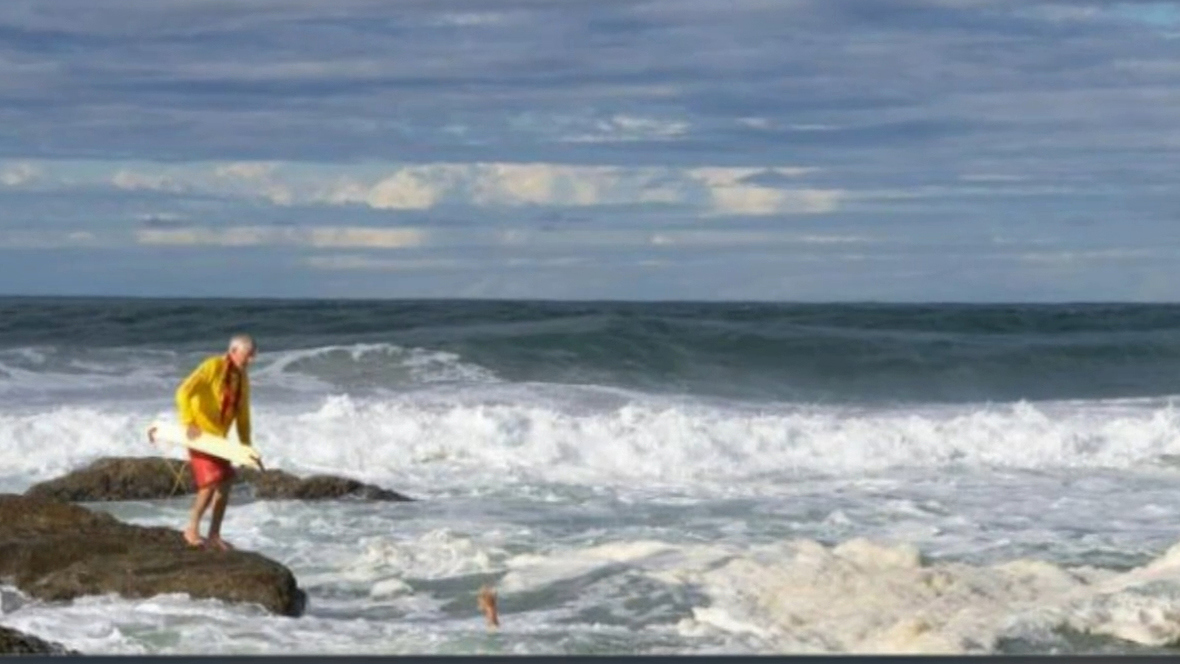 Guests at a gender reveal party for an expectant couple at a Queensland beach risked their lives to try and save a woman who drowned after trying to help her daughter.The 51-year-old mother and teenage daughter got into trouble in the treacherous Froggies Beach swell on the Gold Coast.
Shoieb Fadeh, 31, who was at the party, rushed into the water to help alongside lifesavers after seeing the rescue unfold - but then had to be saved himself.