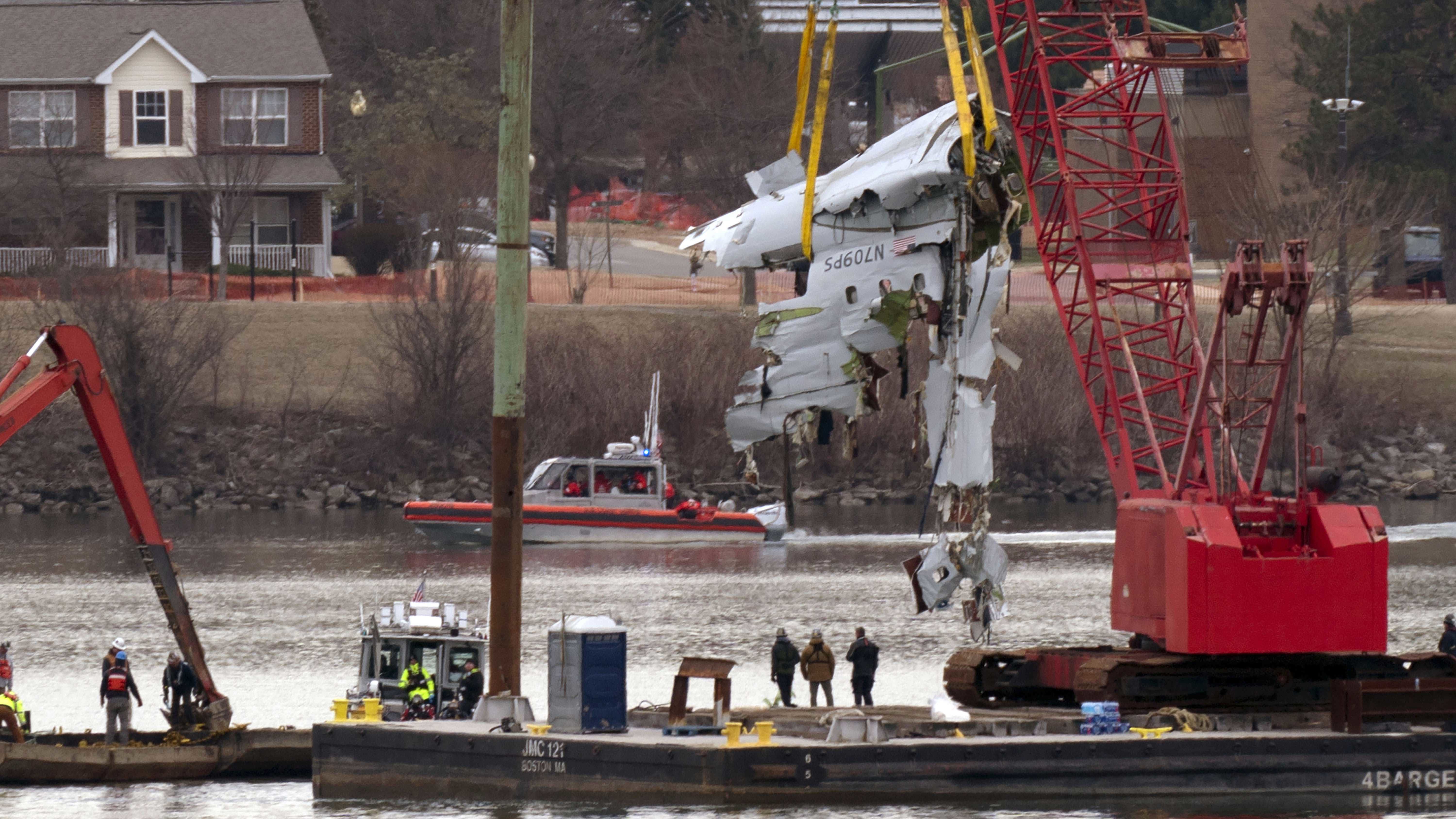 Los equipos de rescate y salvamento sacan restos de aviones de un avión de American Airlines en el río Potomac desde el Aeropuerto Nacional Ronald Reagan Washington.