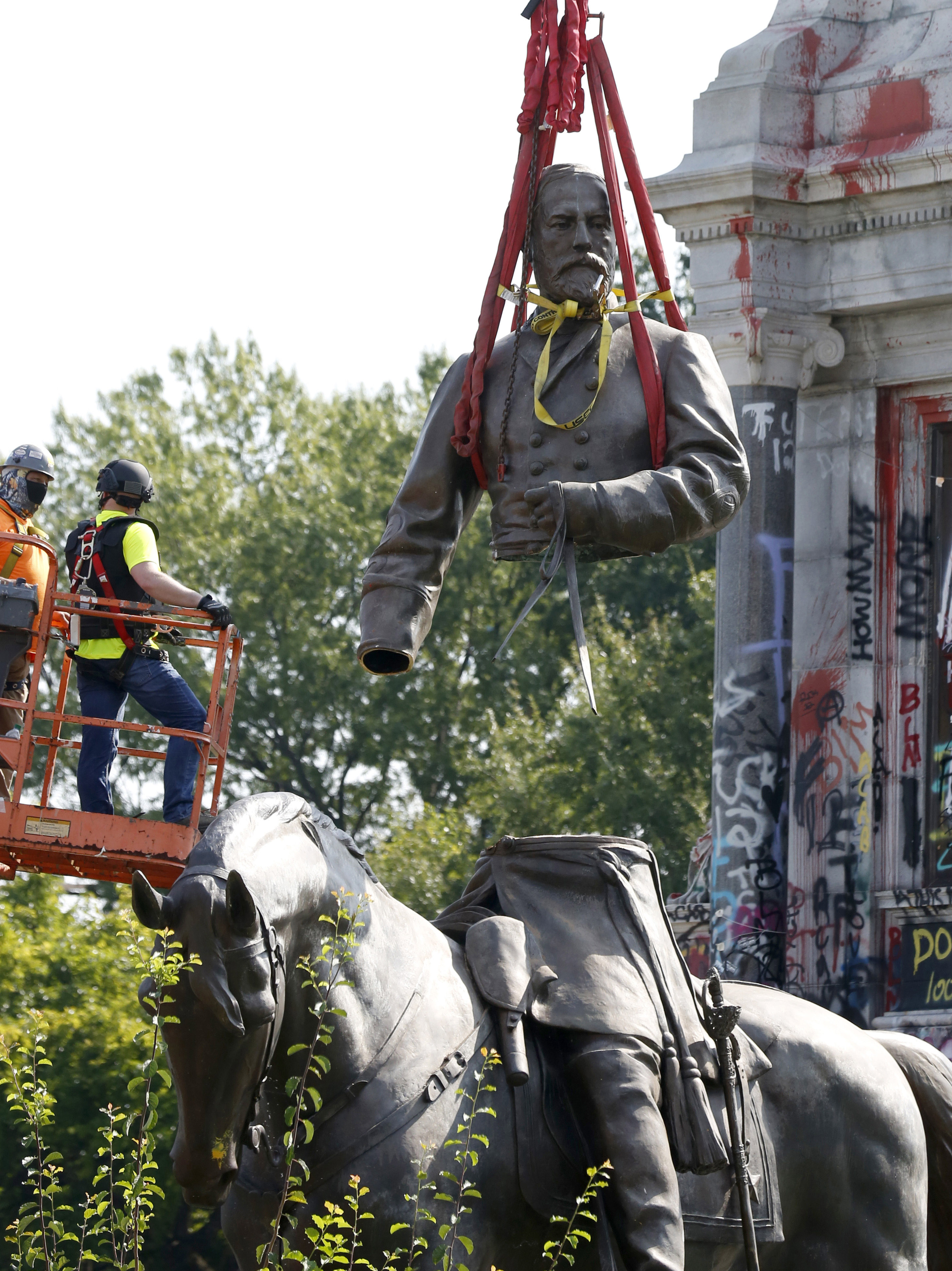 The top part of the General Robert E. Lee statue was lifted during its removal on Monument Avenue in Richmond, Virginia. 