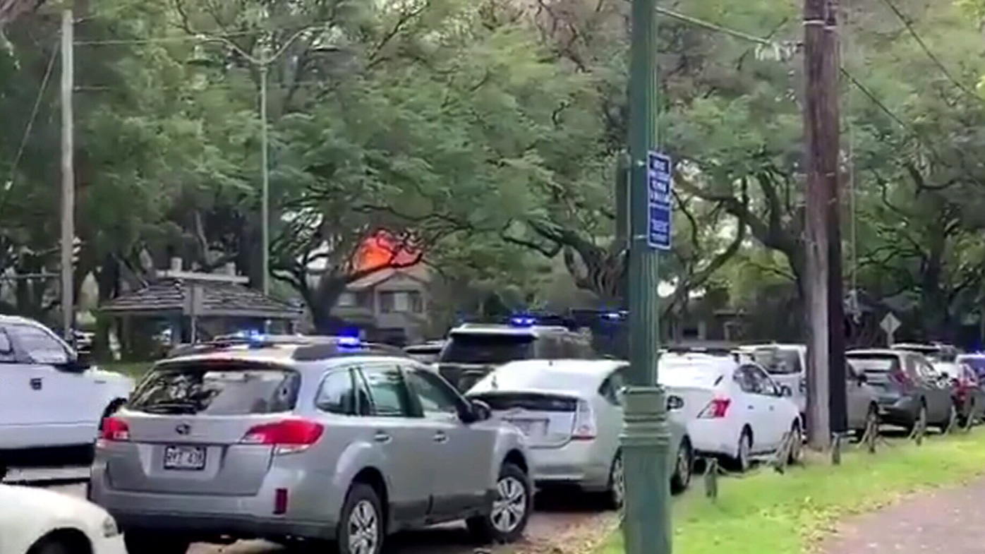 A home burns in the the area of Hibiscus Drive, Honolulu, where at least two have been injured in a shooting. 
