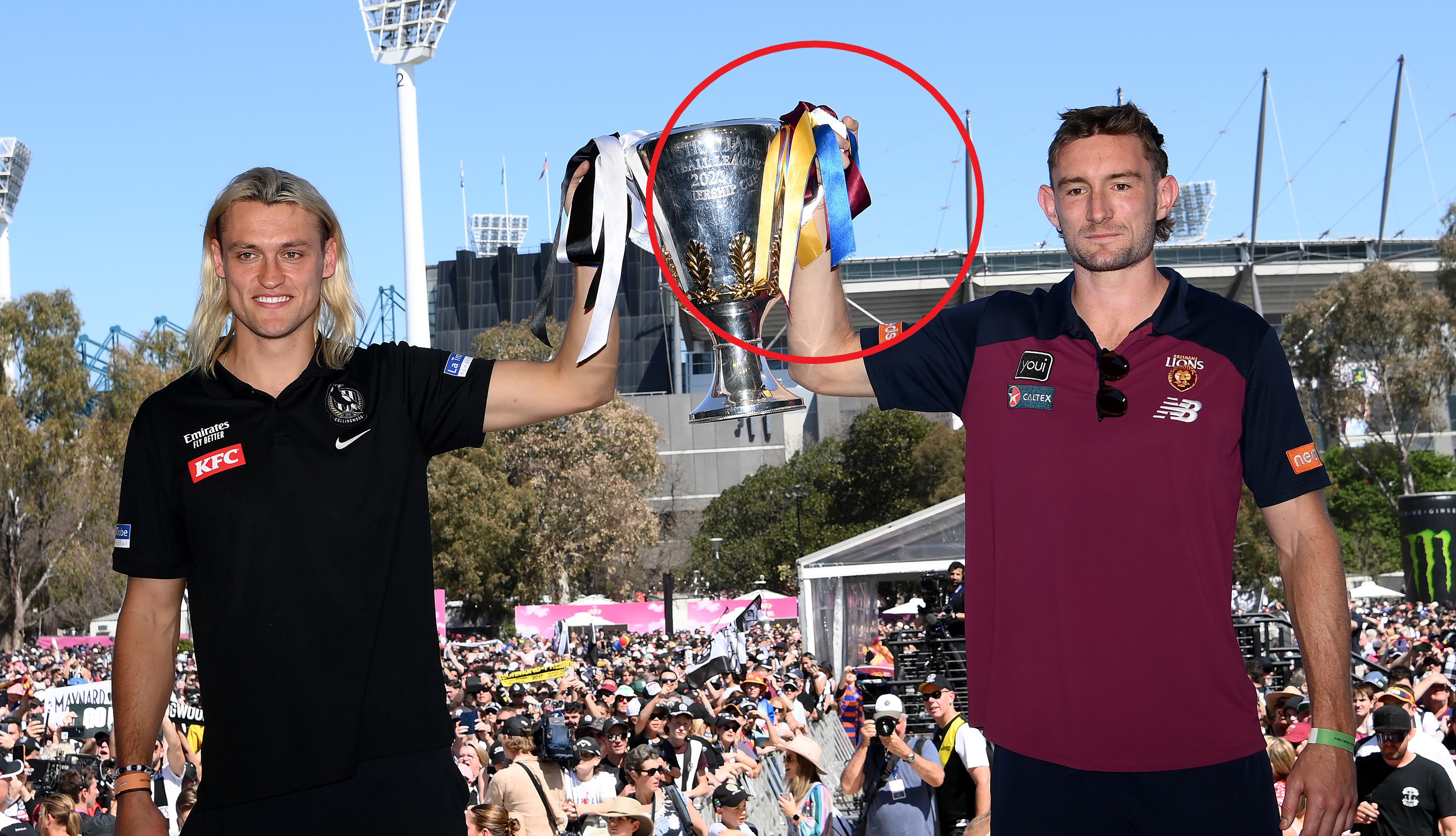Magpies captain Darcy Moore and Lions skipper Harris Andrews with the premiership cup.