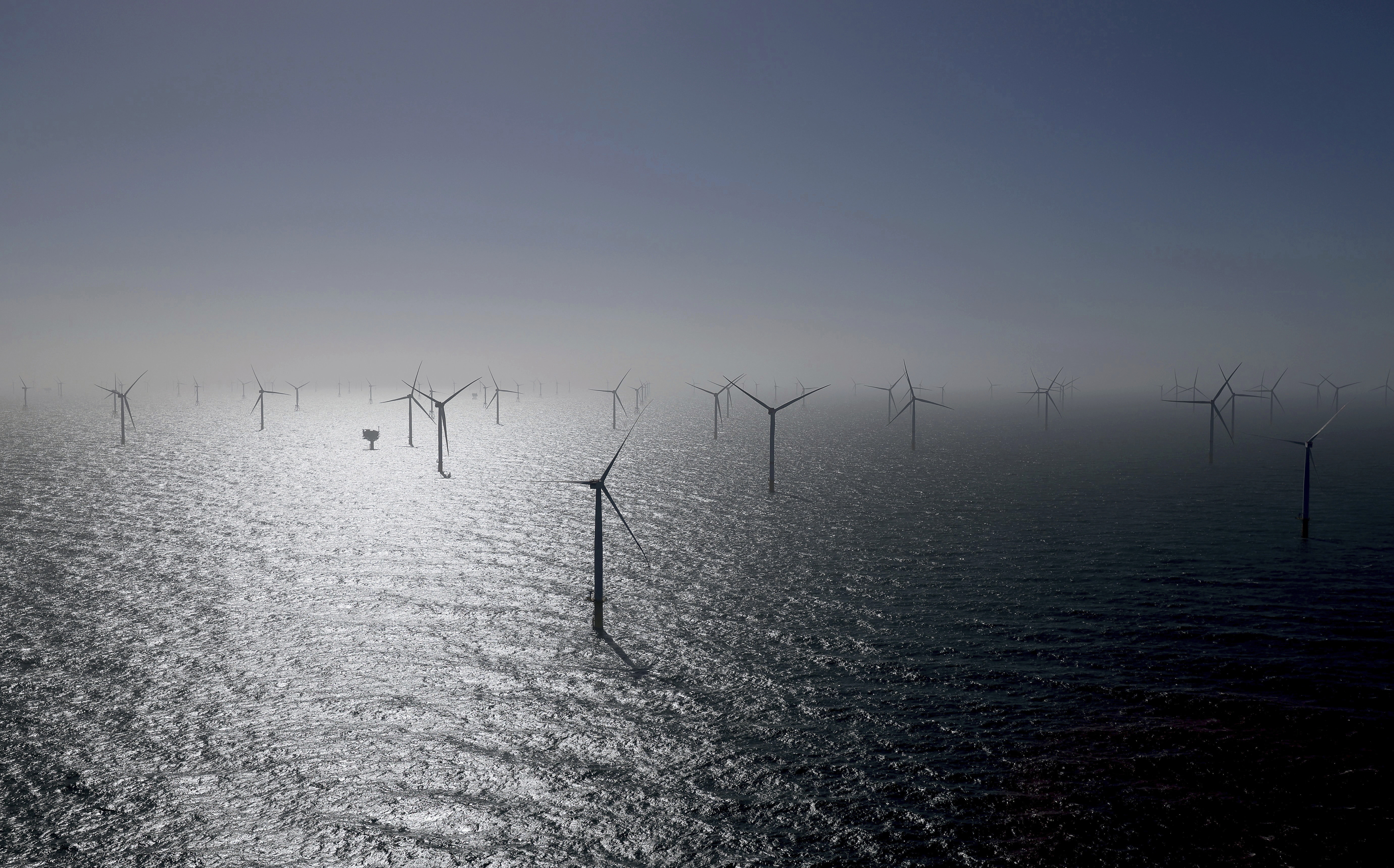 Numerous wind turbines, including some from RWE's new Kaskasi offshore wind farm, can be seen during the commissioning of the wind farm off Helgoland, Germany, Thursday March 23, 2023. (Christian Charisius/Pool via AP)