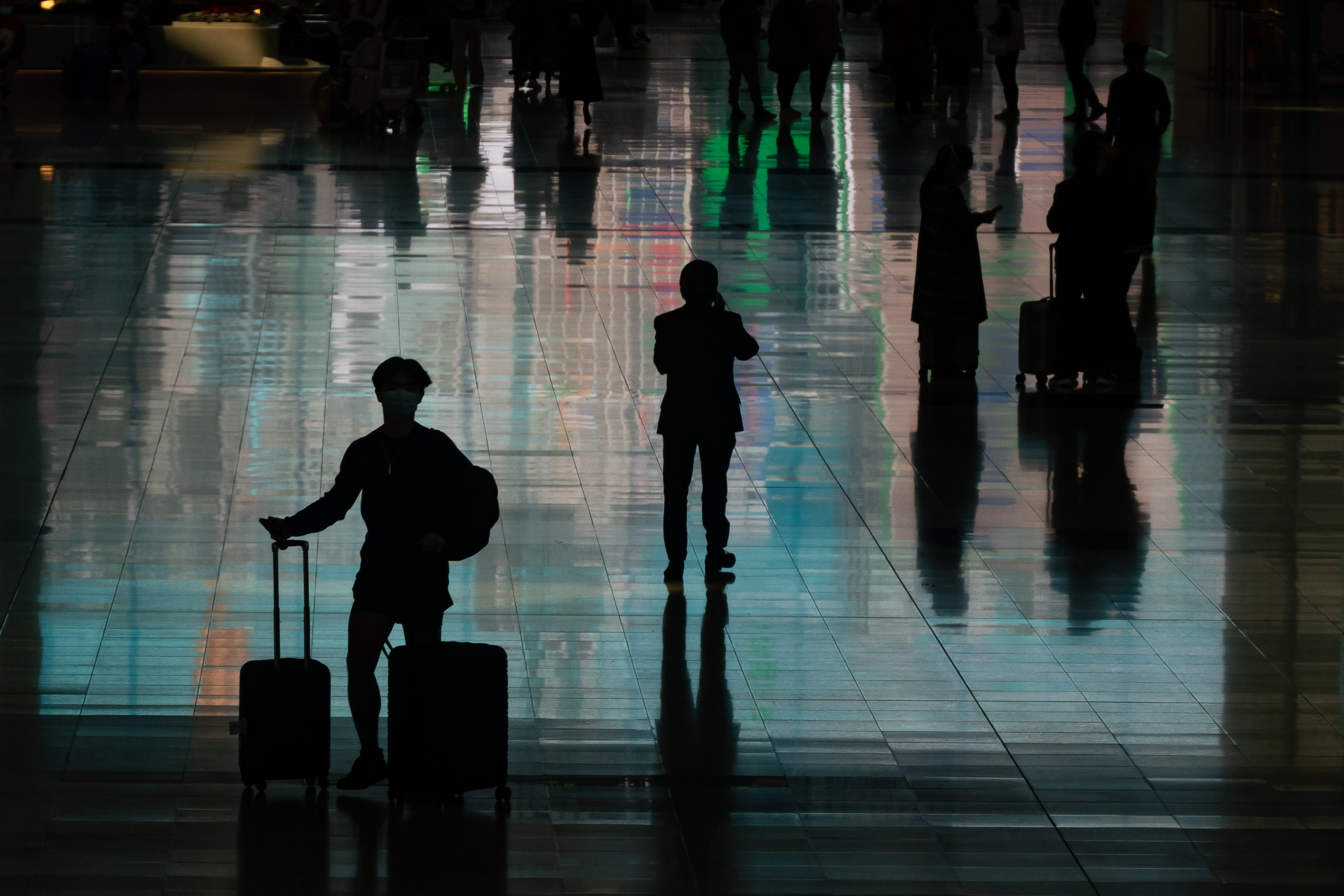 Travellers walk with their luggage at the arrival hall of the Hong Kong International Airport on December 30, 2022 in Hong Kong, China. 