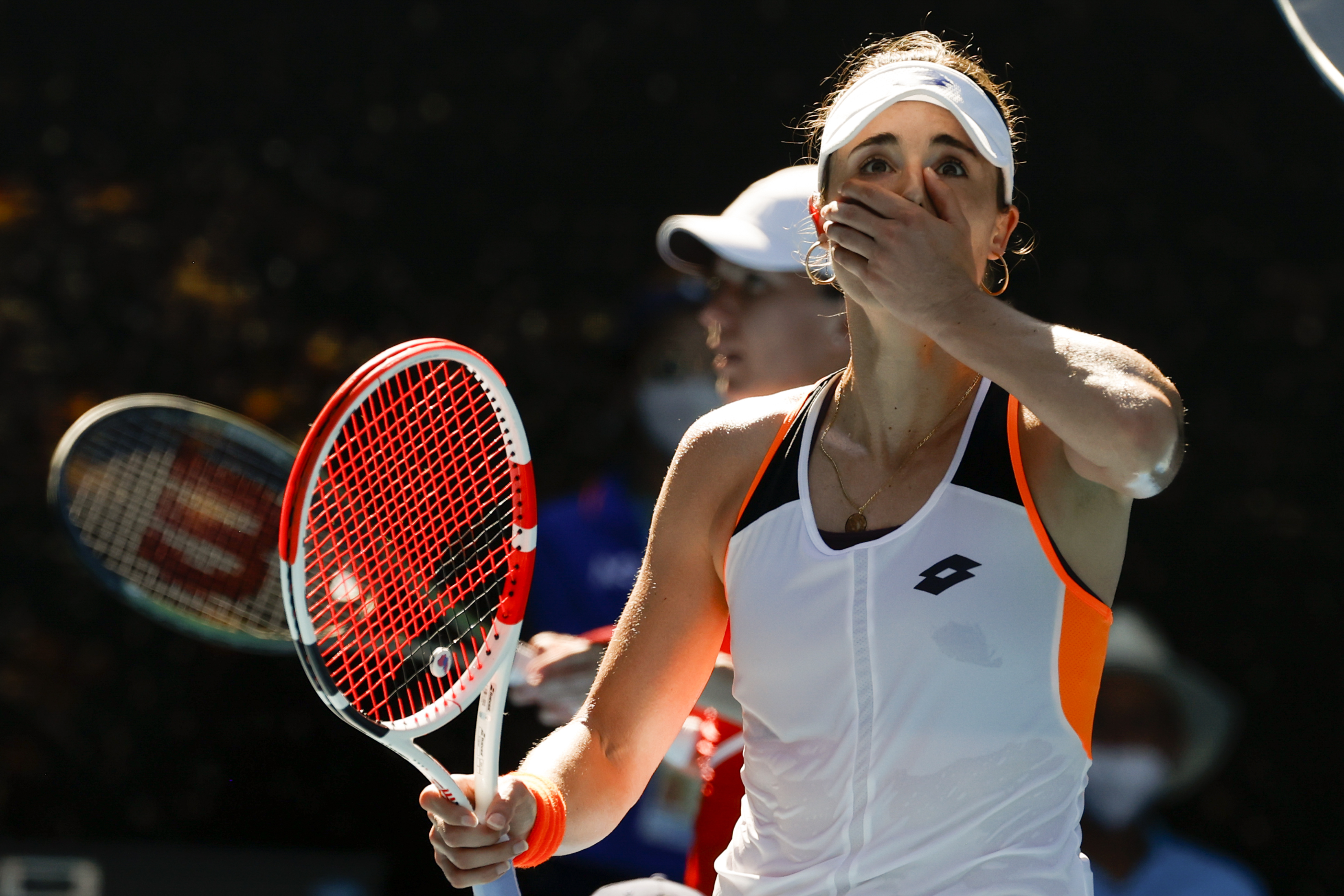 Alize Cornet of France reacts after defeating Simona Halep of Romania in their fourth round match at the Australian Open.