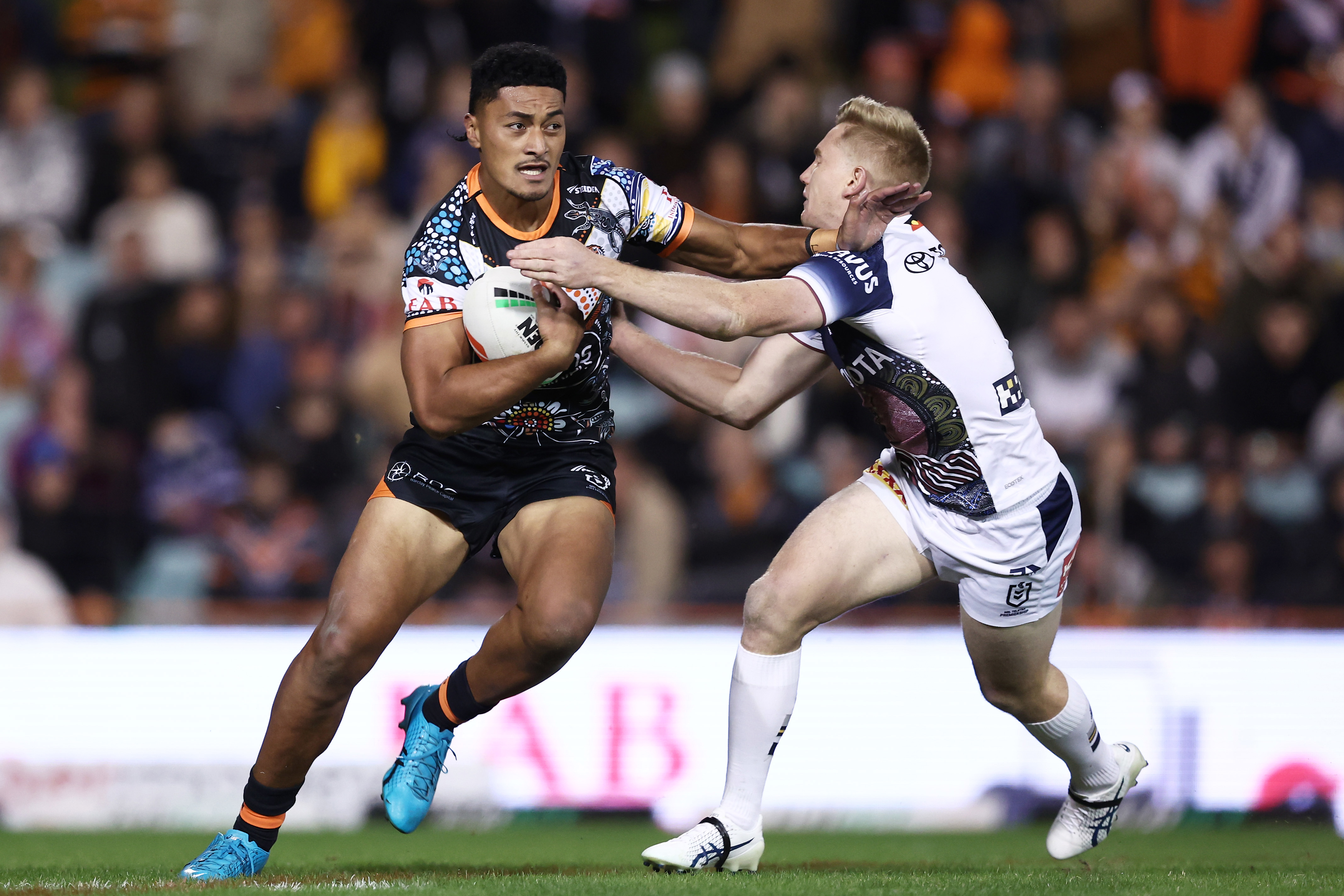  Junior Tupou of the Tigers is tackled by Tom Dearden of the Cowboys during the round 12 NRL match between Wests Tigers and North Queensland Cowboys at Leichhardt Oval on May 20, 2023 in Sydney, Australia. (Photo by Matt King/Getty Images)