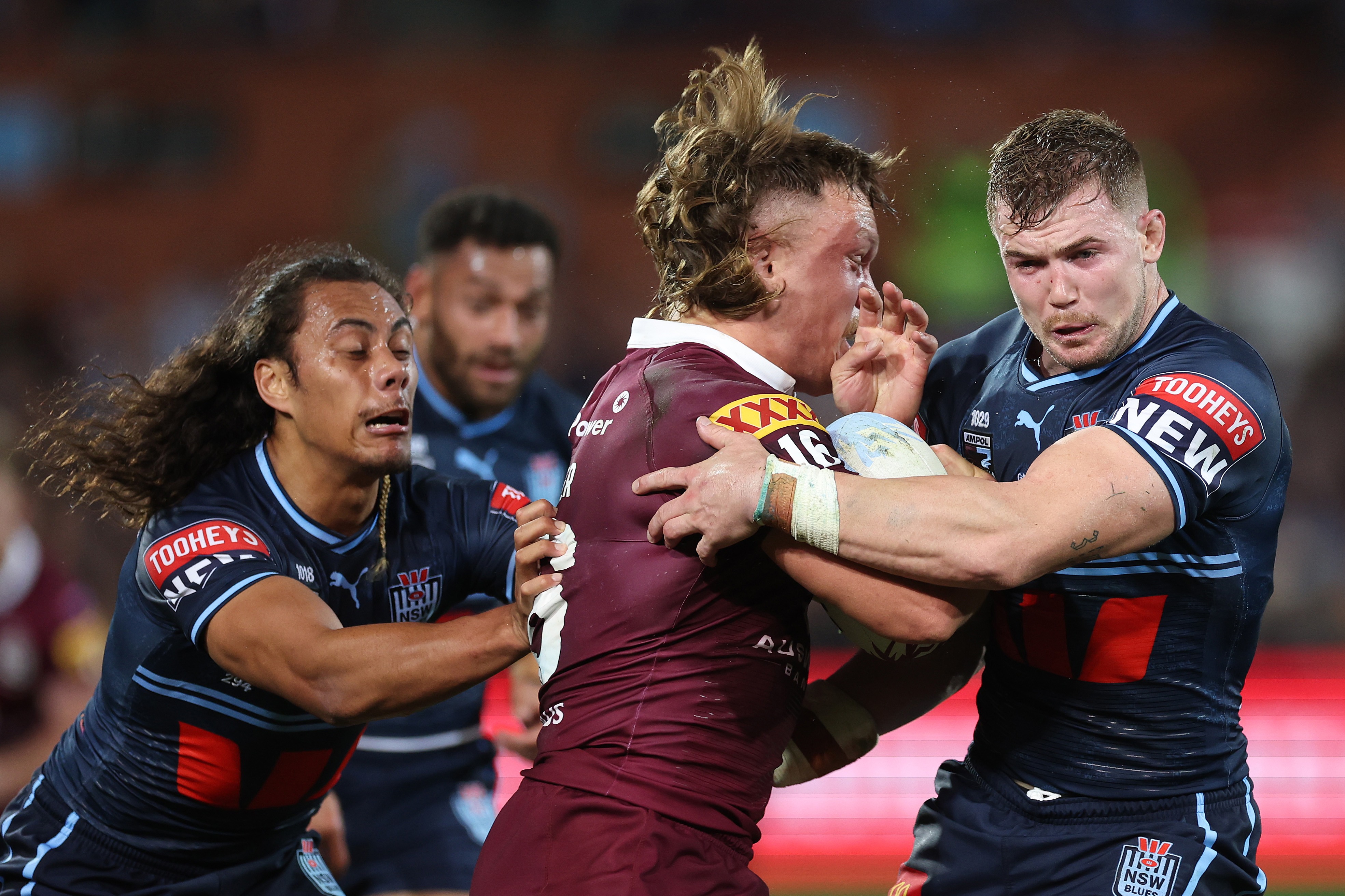 ADELAIDE, AUSTRALIA - MAY 31:  Reuben Cotter of the Maroons is tackled by Hudson Young and Jarome Luai of the Blues during game one of the 2023 State of Origin series between the Queensland Maroons and New South Wales Blues at Adelaide Oval on May 31, 2023 in Adelaide, Australia. (Photo by Mark Kolbe/Getty Images)