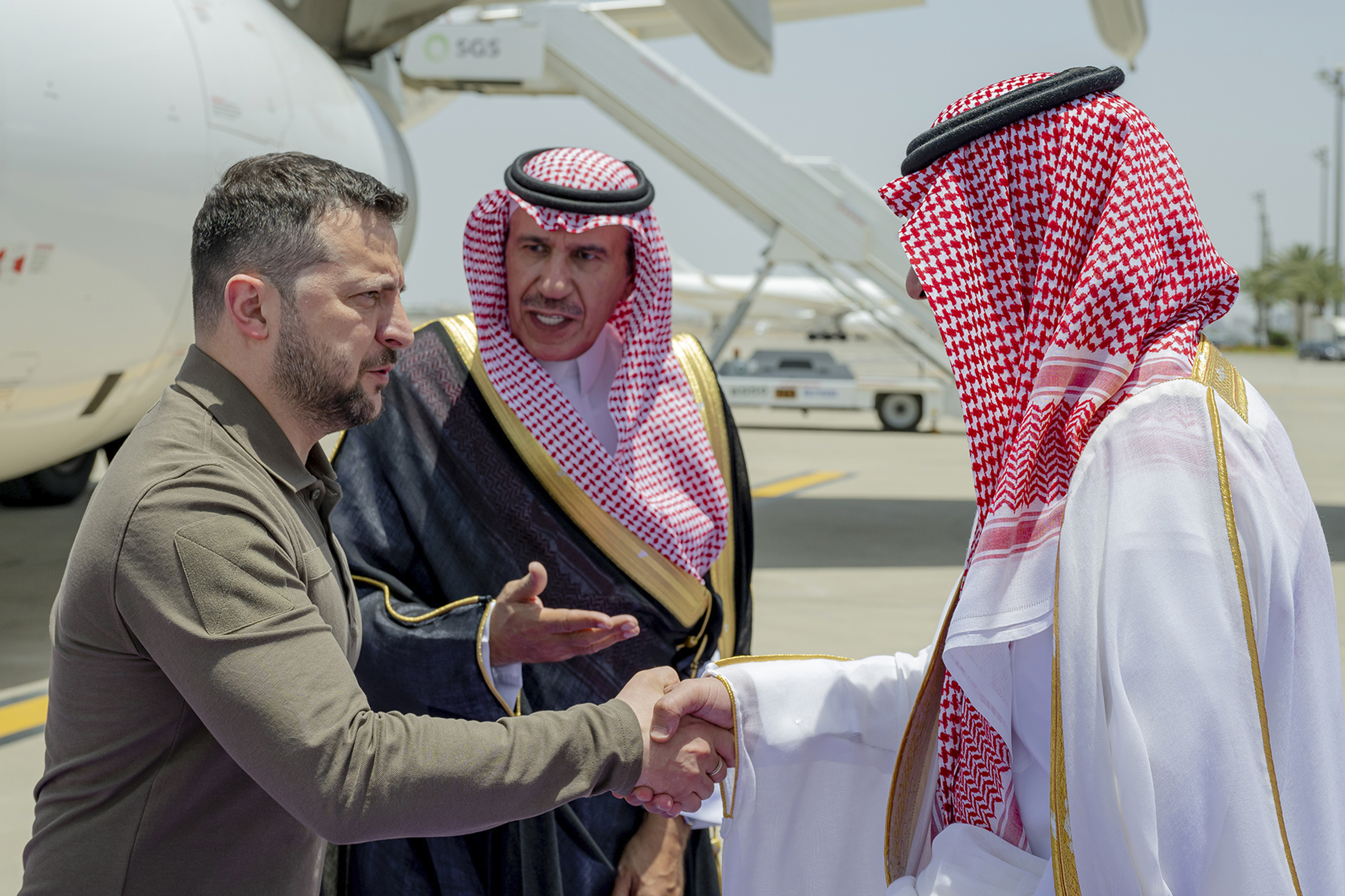 Ukraine's President Volodymyr Zelenskyy, left, is greeted by Prince Badr Bin Sultan, deputy governor of Mecca, upon his arrival at Jeddah airport, Saudi Arabia, Friday, May 19, 2023, to attend the Arab summit