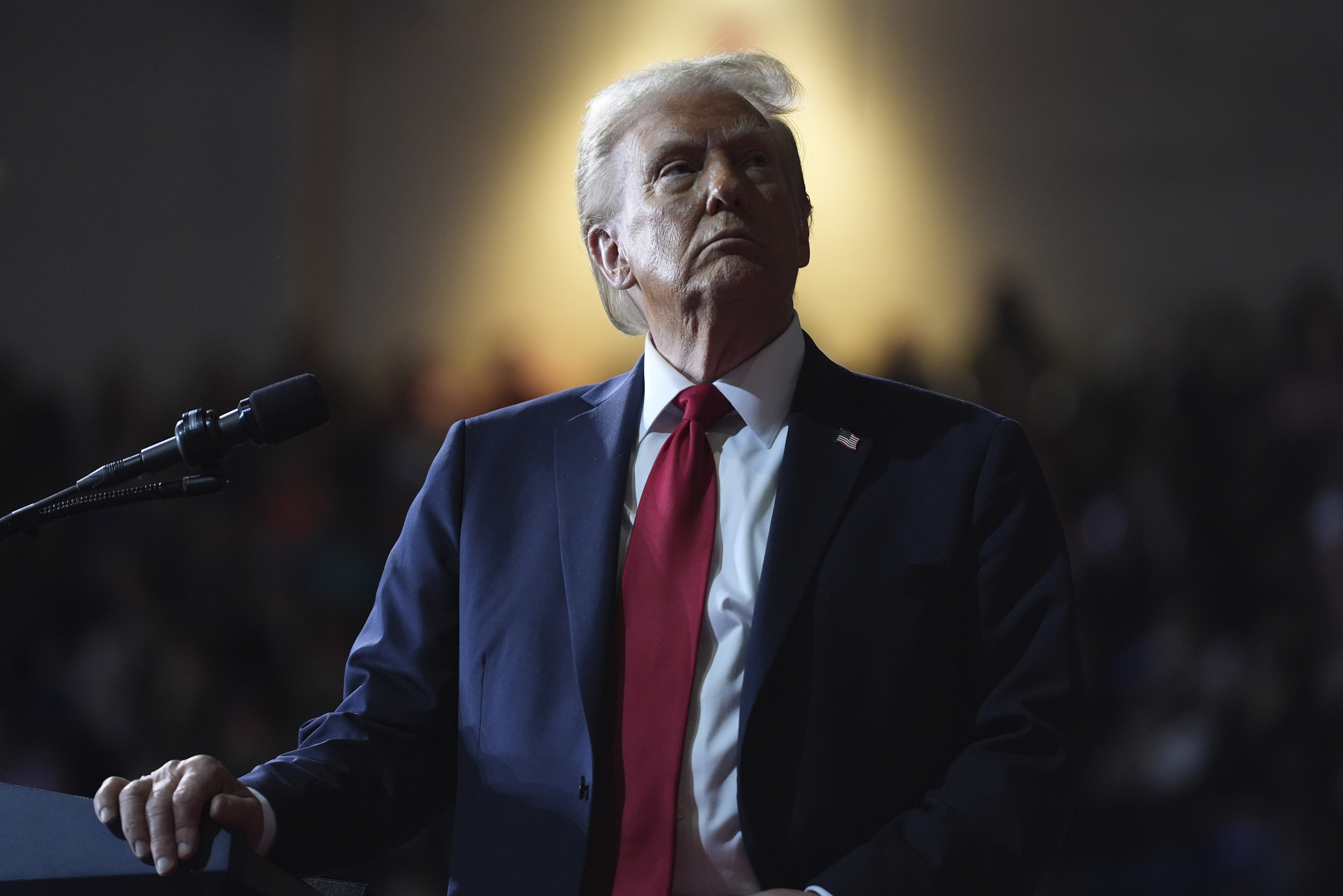 President Donald Trump watches a video screen at a campaign rally.