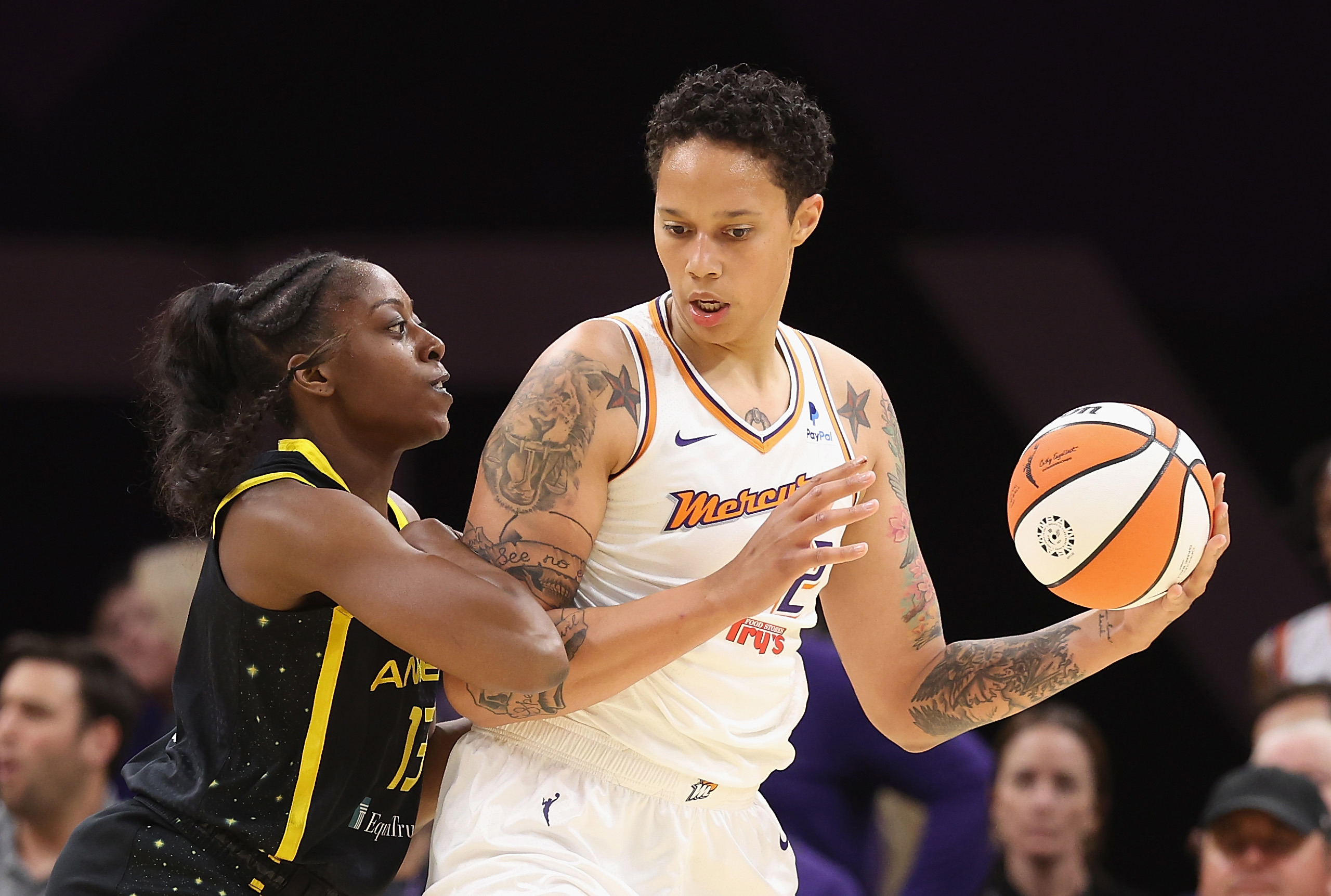 Brittney Griner #42 of the Phoenix Mercury handles the ball against Chiney Ogwumike #13 of the Los Angeles Sparks during the first half of the WNBA game at Footprint Center on May 12, 2023 in Phoenix, Arizona. 