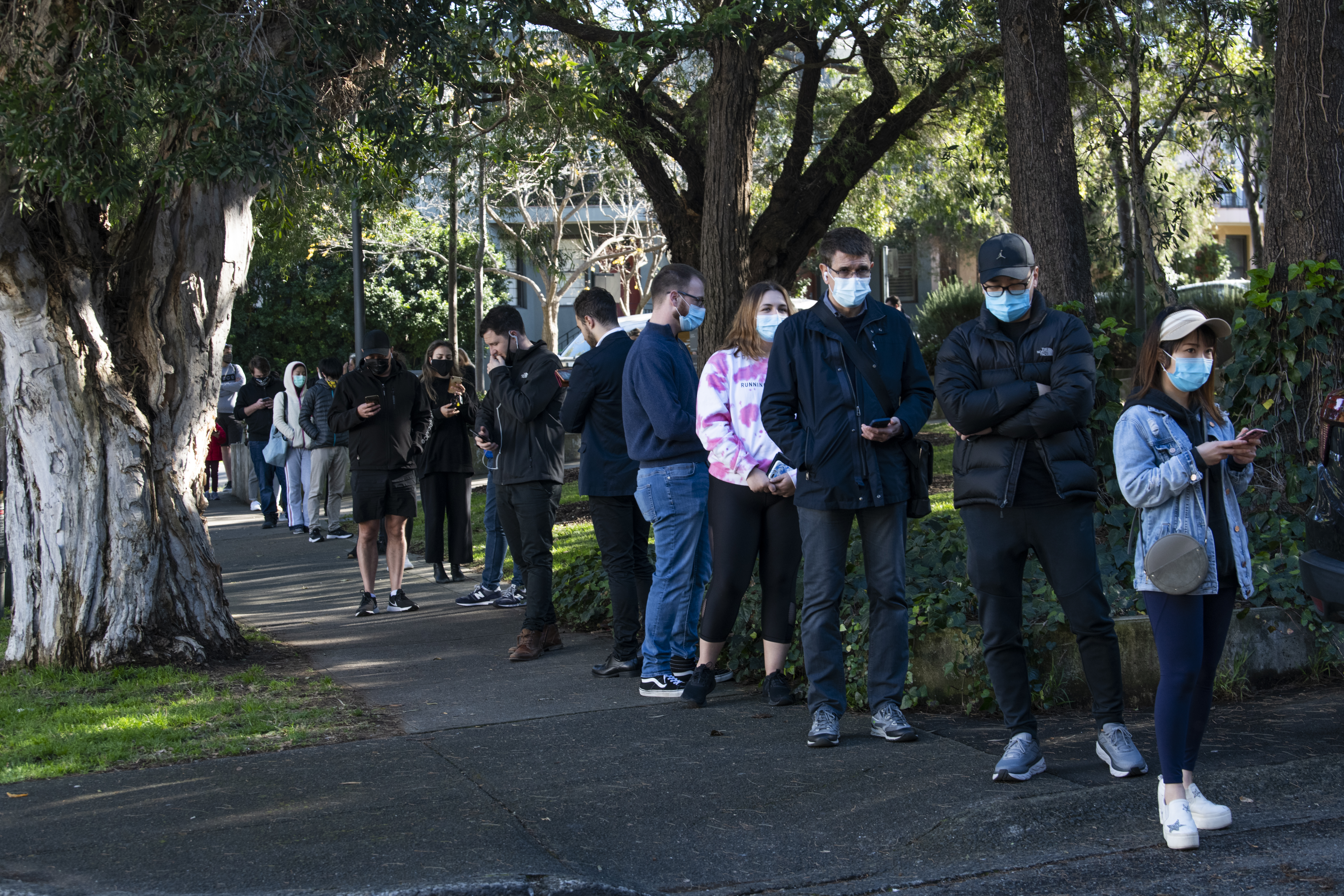 People queuing for a COVID test at a pop up clinic on Beaconsfield St, Alexandria after two local acquired COVID-19 cases were detected.