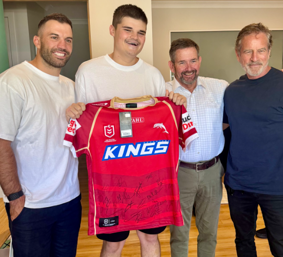 Probationary Constable Jack Hibbert was visited by Sydney Roosters captain James Tedesco a gifted a signed Redcliffe Dolphins jersey.