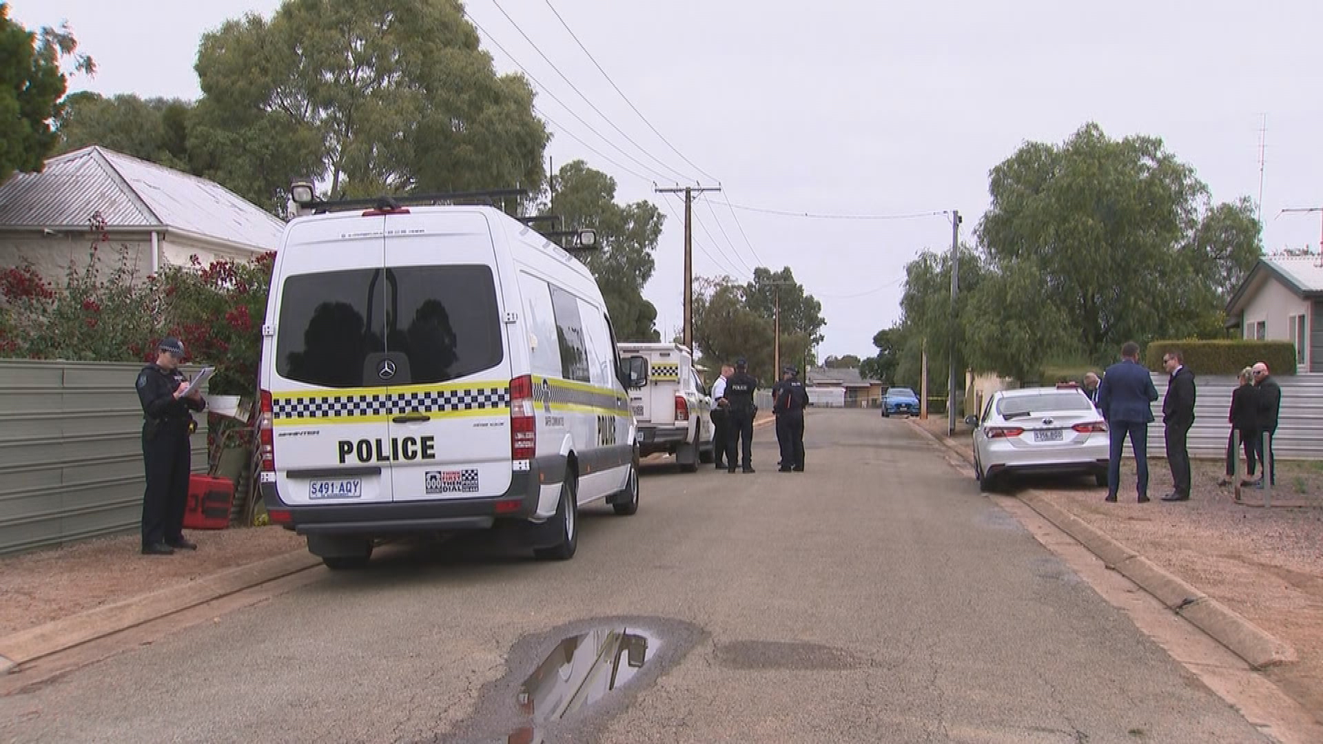 Investigators at the scene of a Crystal Brooke home where two police officers were stabbed.