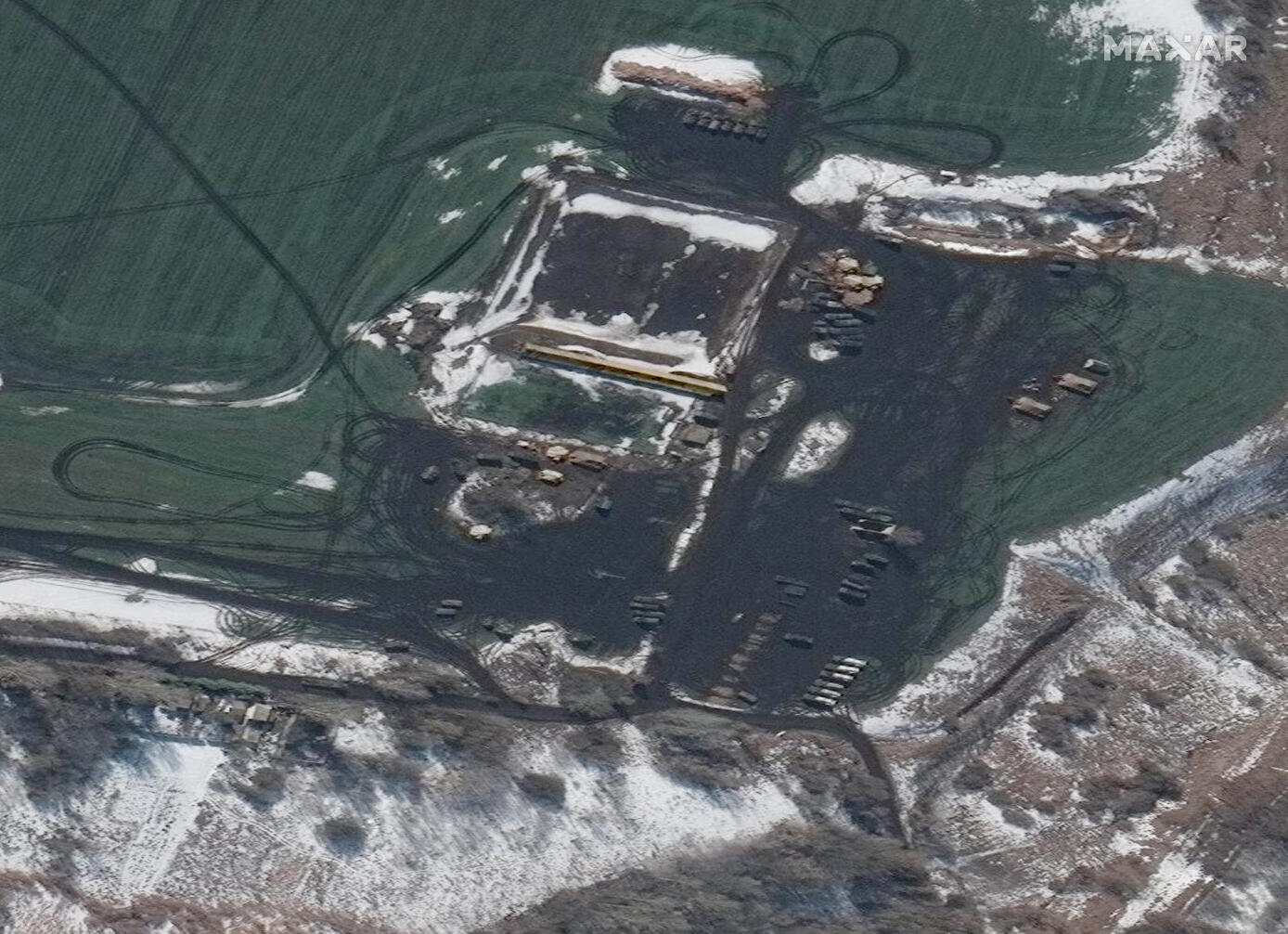 This Thursday, Feb. 24, 2022, satellite image provided by Maxar Technologies shows Russian forces remain deployed in and around the western outskirts of Belgorod, Russia, with artillery and multiple rocket launchers deployed in the area, approximately 10 miles north of the border with Ukraine. (Satellite image ©2022 Maxar Technologies via AP)