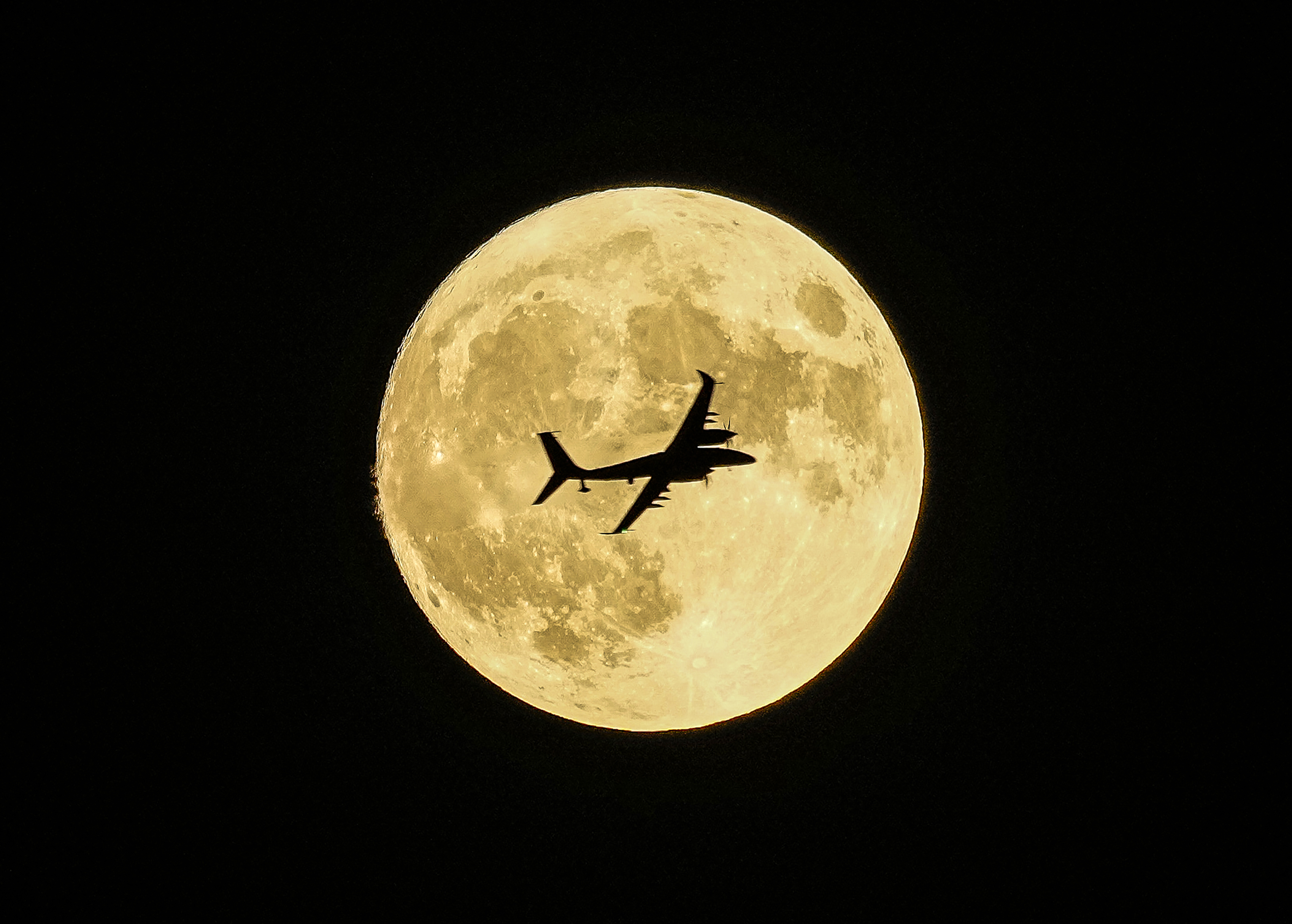 Aknc unmanned aerial craft passing in front of the Supermoon during a demonstration flight on the first day of Teknofest technology and aerospace festival in Ankara, Turkey, Wednesday, Aug. 30, 2023.