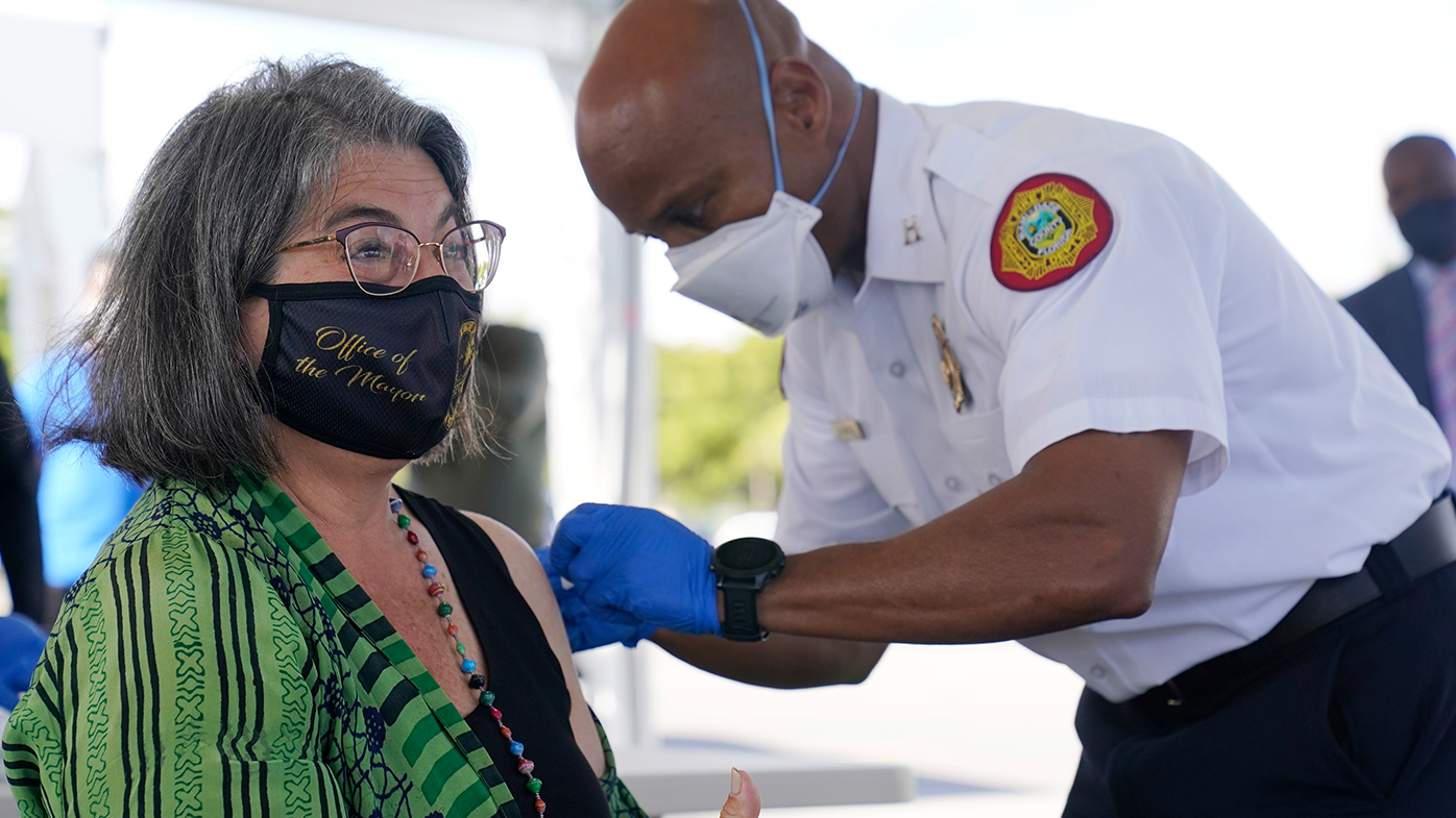 Miami-Dade County Mayor Daniella Levine Cava gives a thumbs up after getting her first dose of Pfizer's COVID-19 vaccine. Once the epicentre for the virus in the US, Florida is still seeing thousands of infections a day. (AP Photo/Wilfredo Lee)