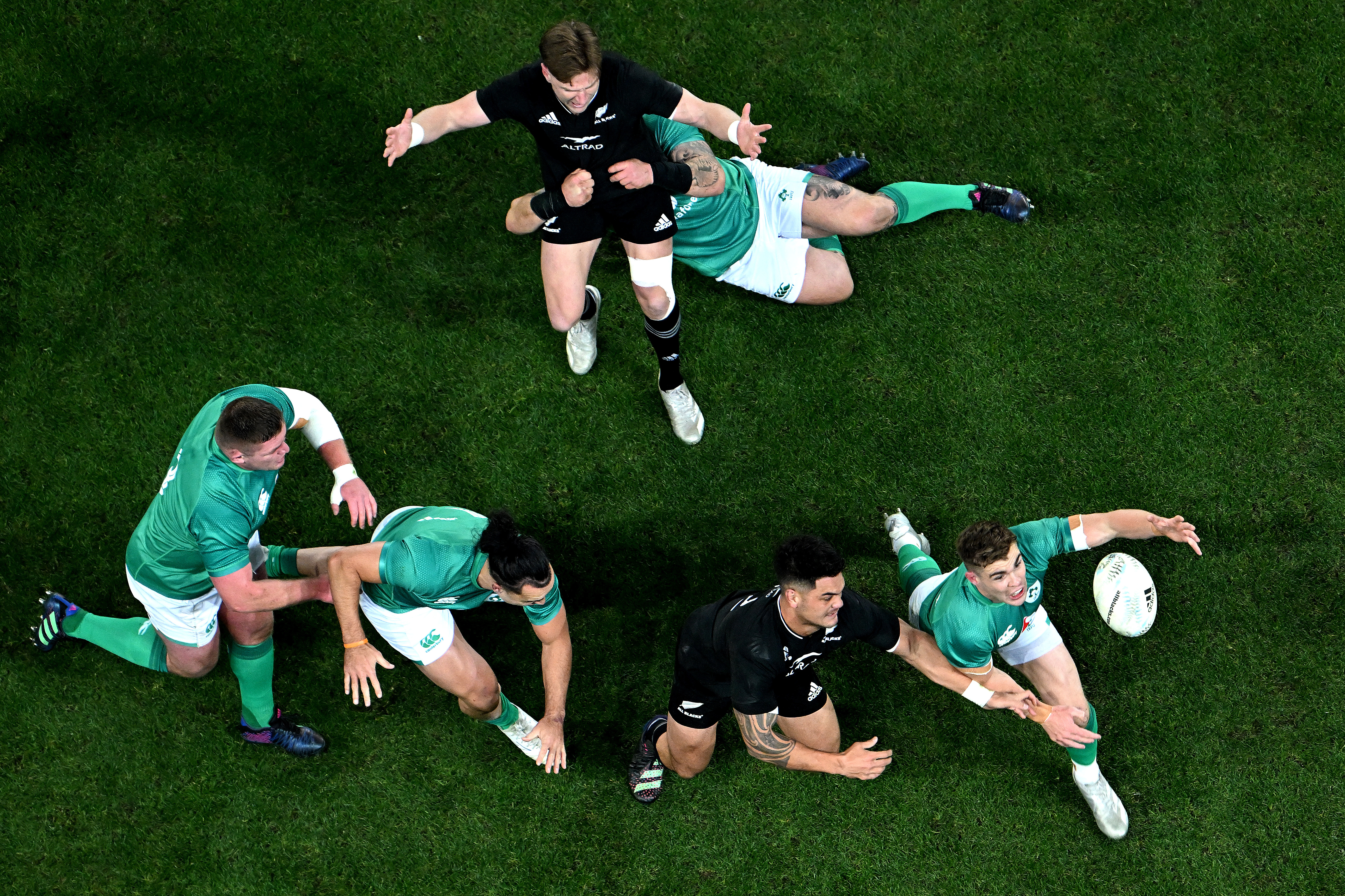 Hugo Keenan of Ireland looks to secure the ball away from Quinn Tupaea of the All Blacks during a Test in 2022.