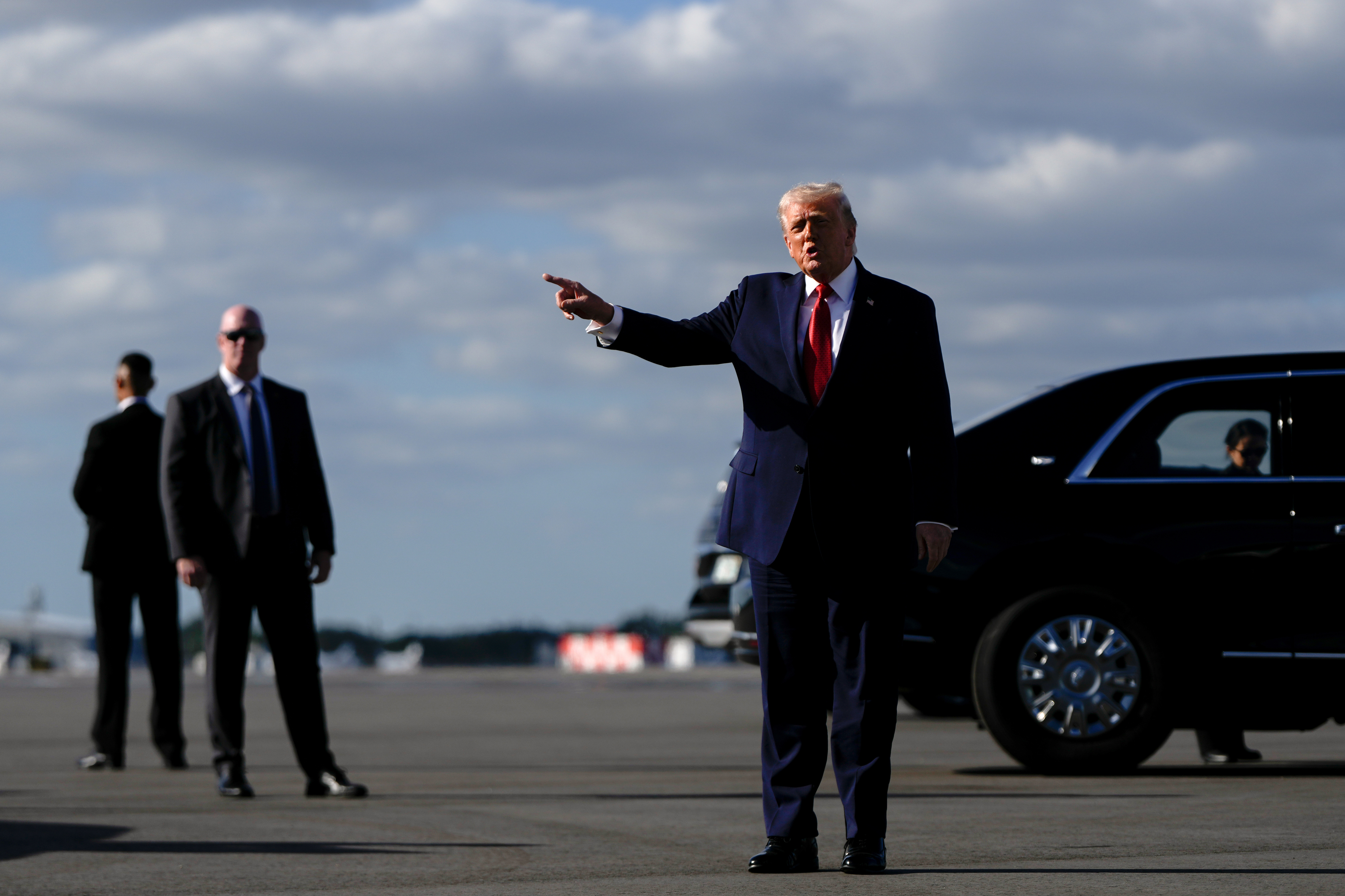 President Donald Trump points after arriving at Palm Beach International Airport on Air Force One, Friday, Jan. 16, 2026, in West Palm Beach, Fla. (AP Photo/Julia Demaree Nikhinson)
