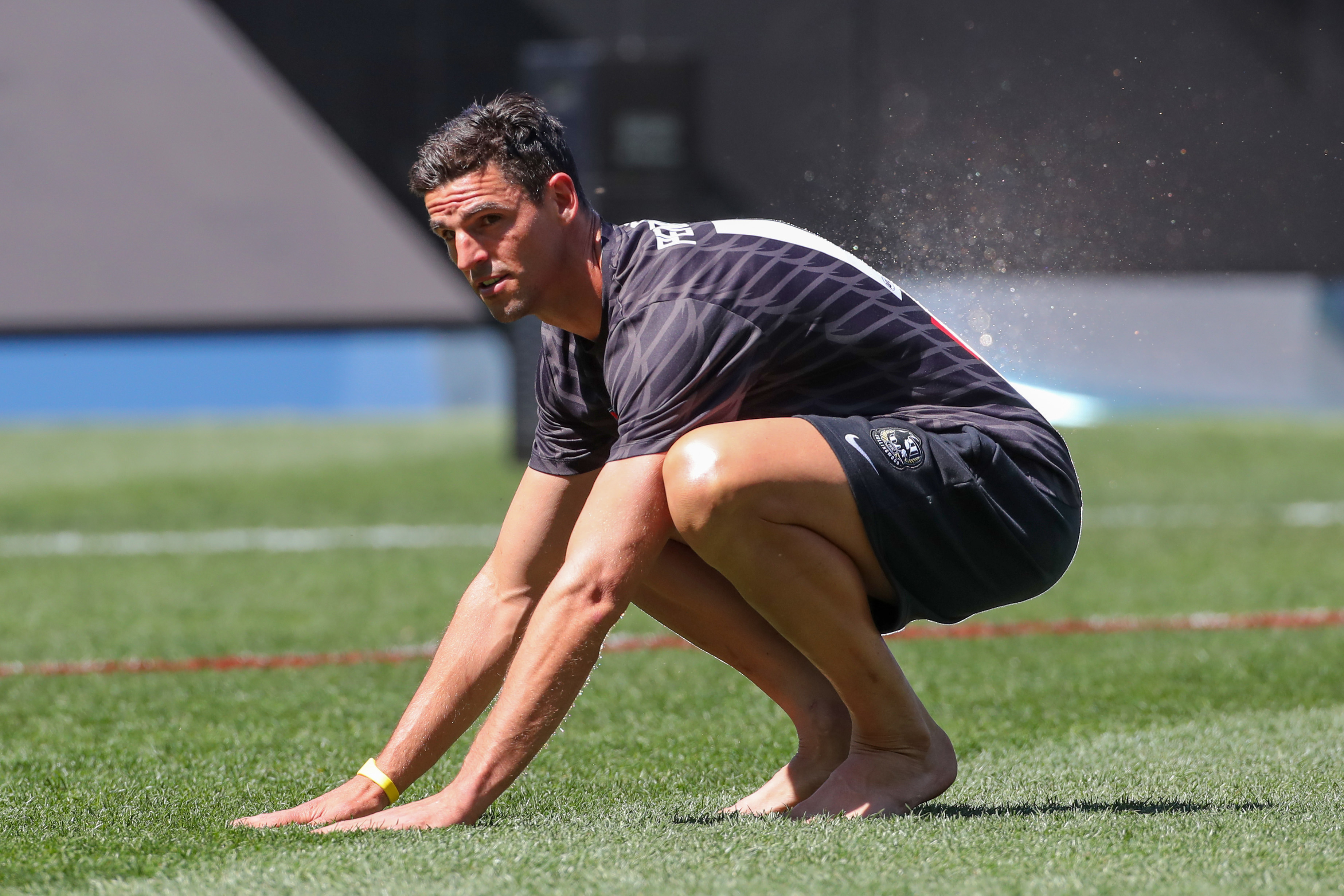 Magpies veteran Scott Pendlebury gets in touch with the MCG surface before the grand final.