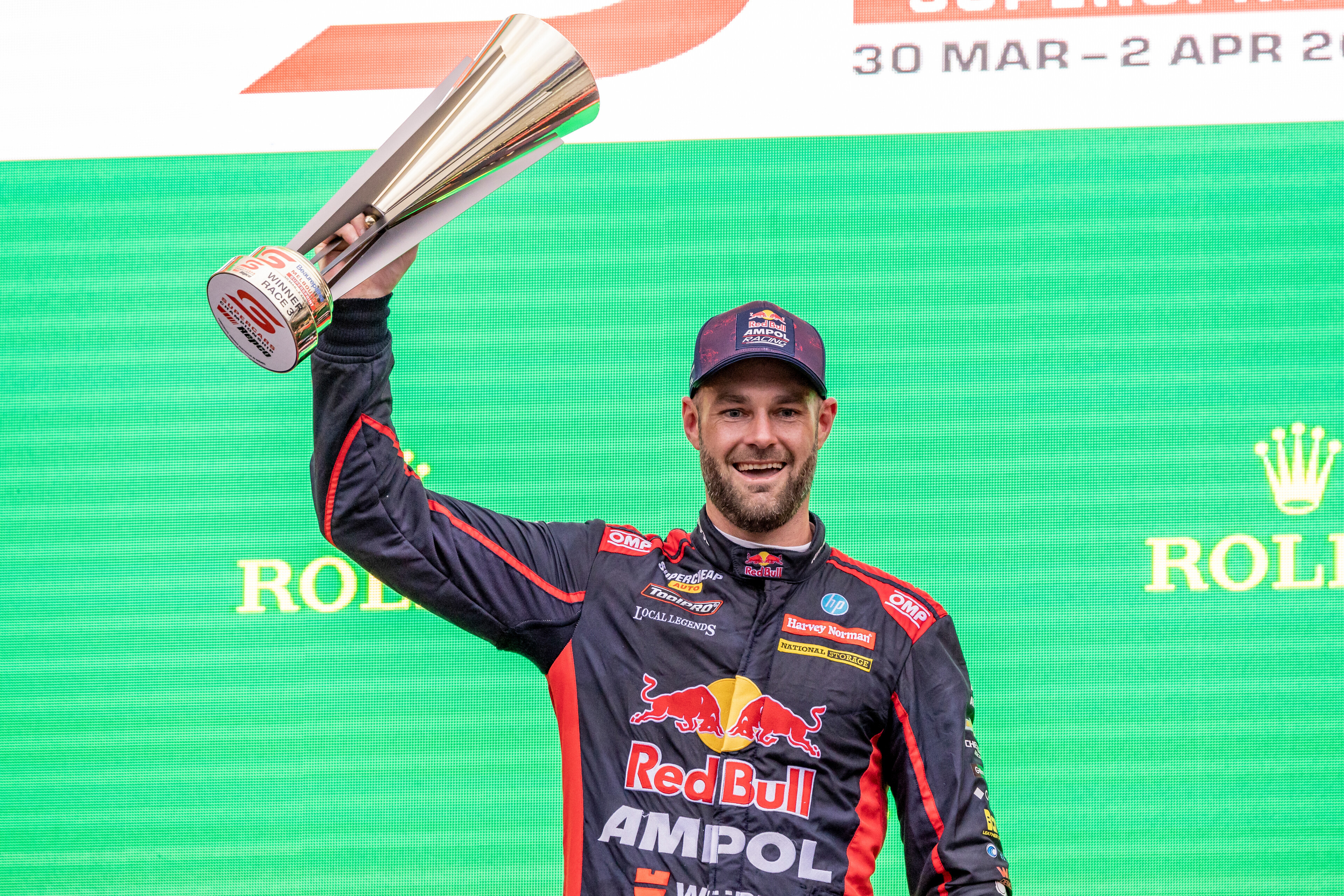 Shane van Gisbergen stands on the podium at the Formula 1 Australian Grand Prix.