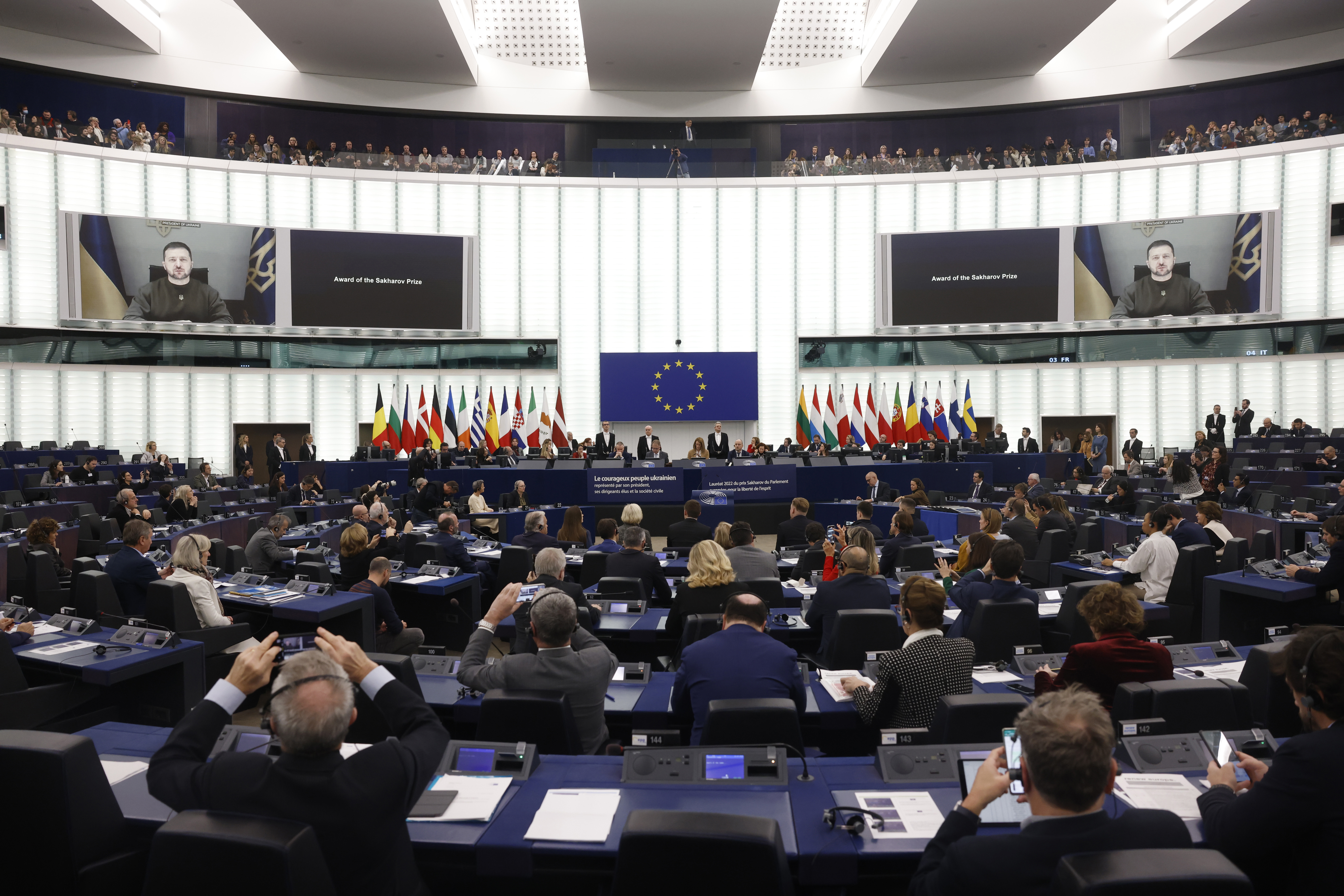 President of Ukraine Volodymyr Zelensky appears on screen as he speaks to the representatives of the Ukrainian people receiving the 2022 Sakharov Prize for Freedom of Thought Award, the European Union top human rights prize, Wednesday, December 14, 2022 in Strasbourg, eastern France 