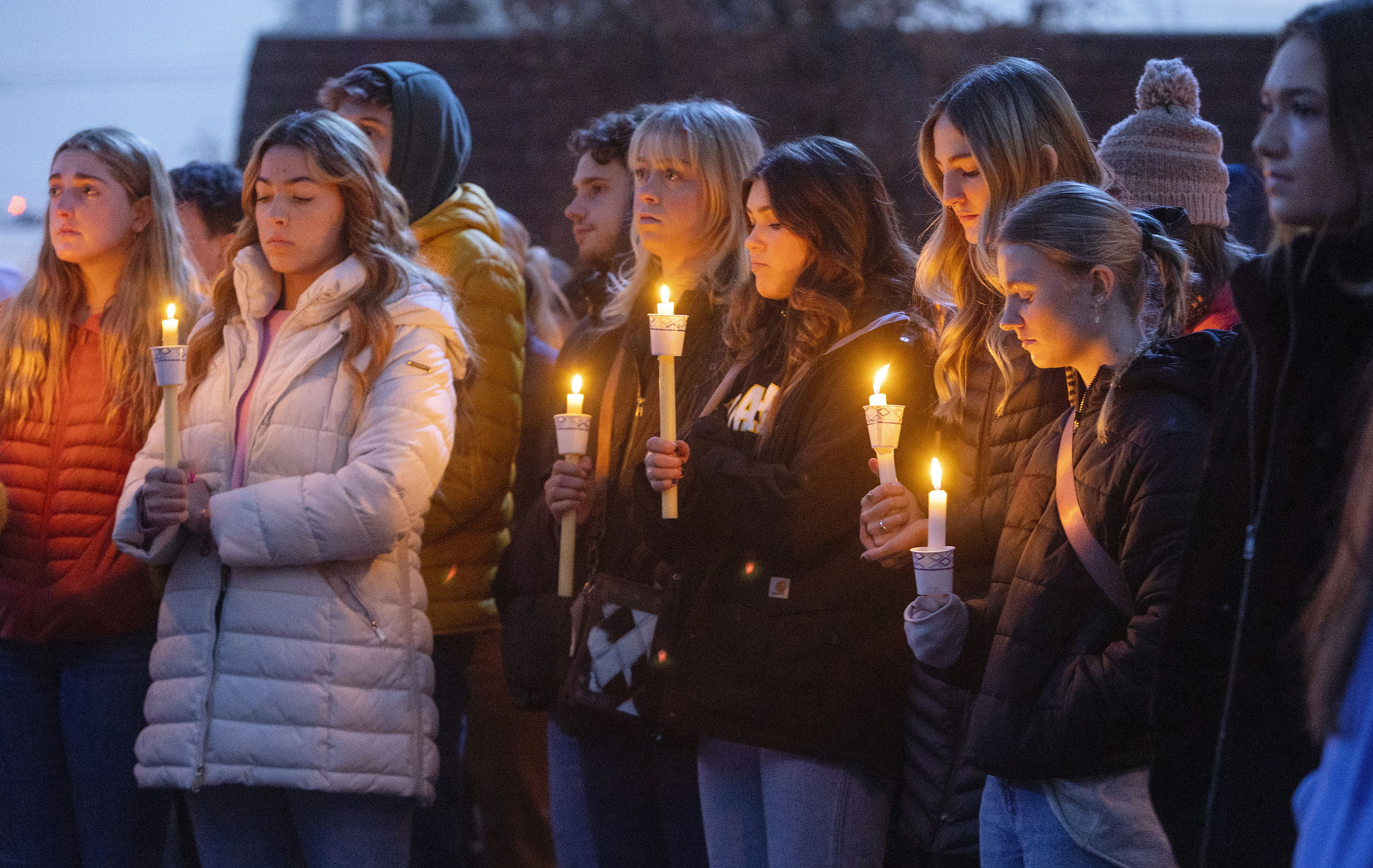 Boise State University students, along with people who knew the four University of Idaho students who were found killed in Moscow, Idaho, days earlier, pay their respects at a vigil held in front of a statue on the Boise State campus, Thursday, Nov. 17, 2022, in Boise, Idaho. 