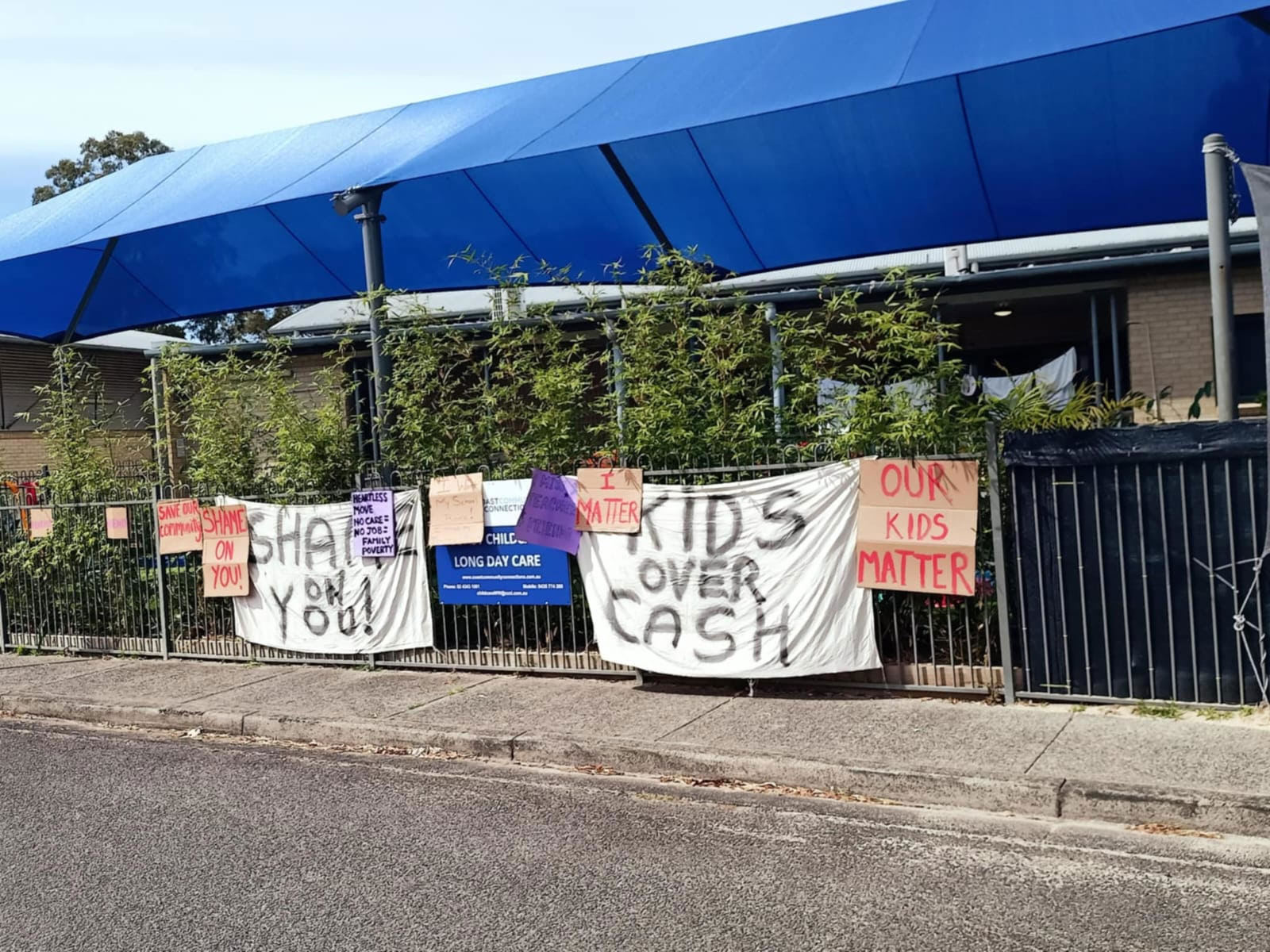 Families protest outside the daycare in Woy Woy.