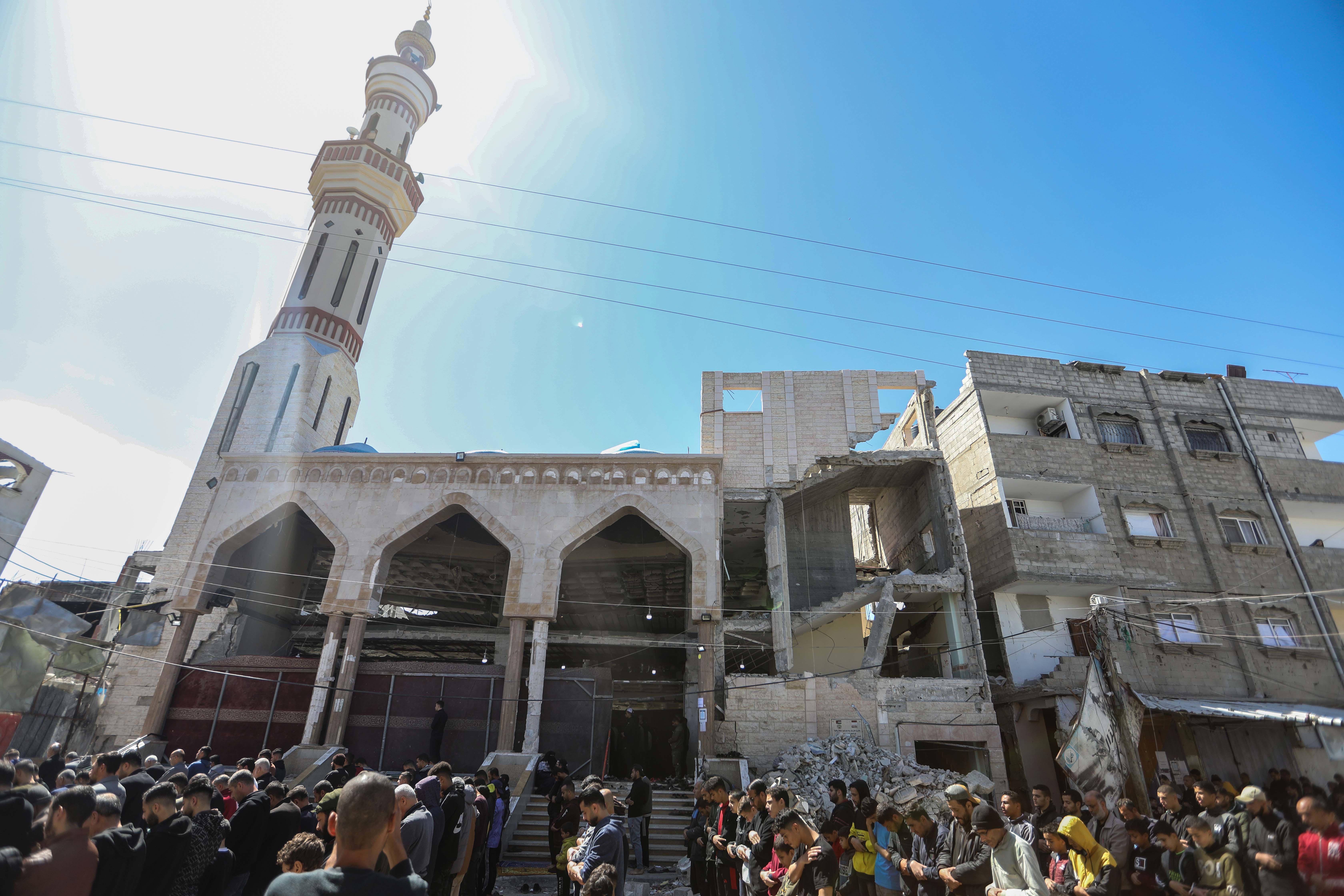 Palestinians perform the first Friday prayer of the holy month of Ramadan on the ruins of Al-Huda Mosque, that was partially destroyed by Israeli airstrikes on March 15, 2024 in Rafah, Gaza. 